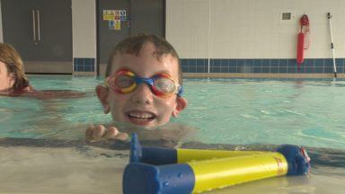 Youngster defies odds learning to swim year after spinal surgery