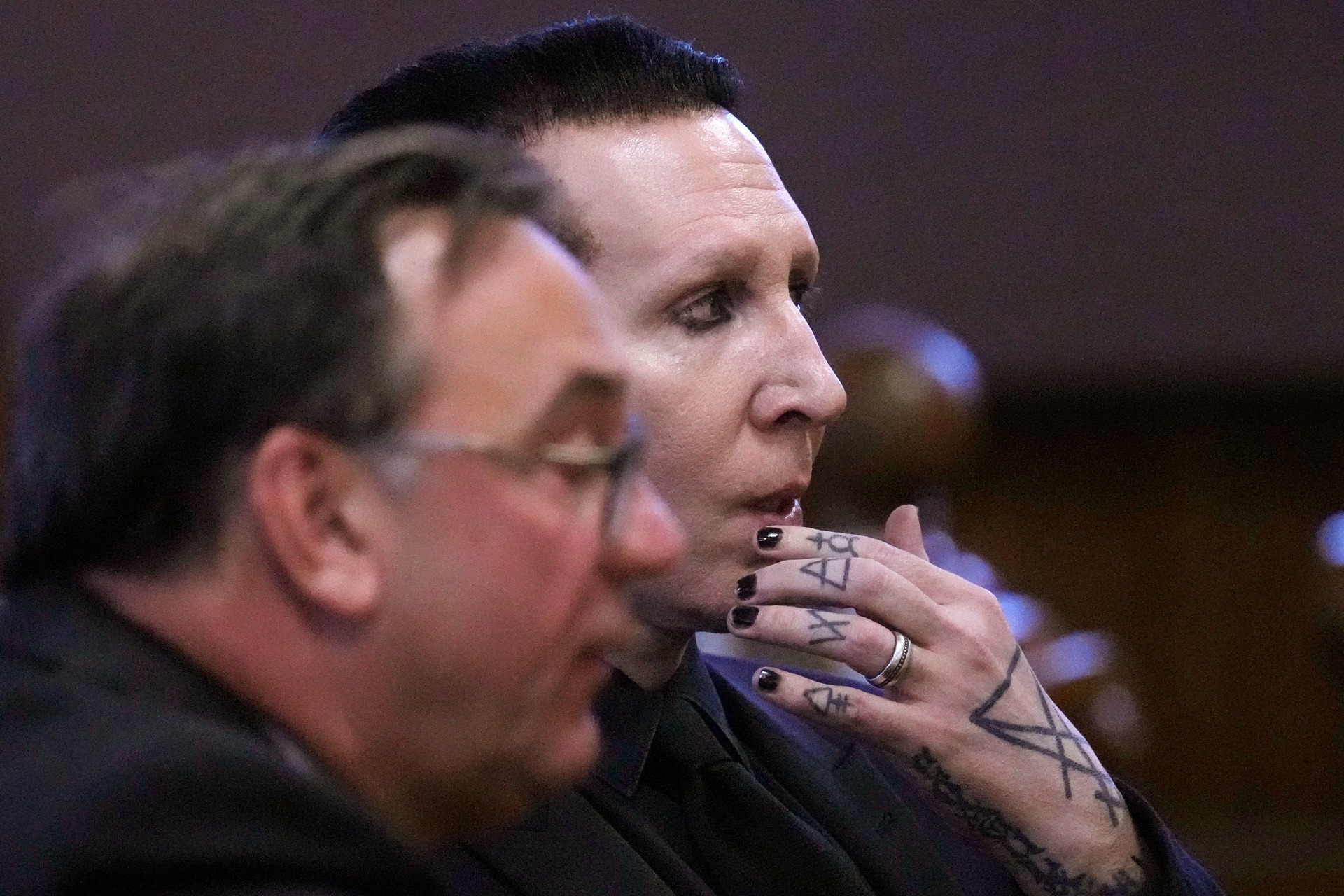 Marilyn Manson, whose legal name is Brian Hugh Warner, right, sits with his lawyer Kent Barker during an appearance in Belknap Superior Court on Monday (Charles Krupa/AP/PA)
