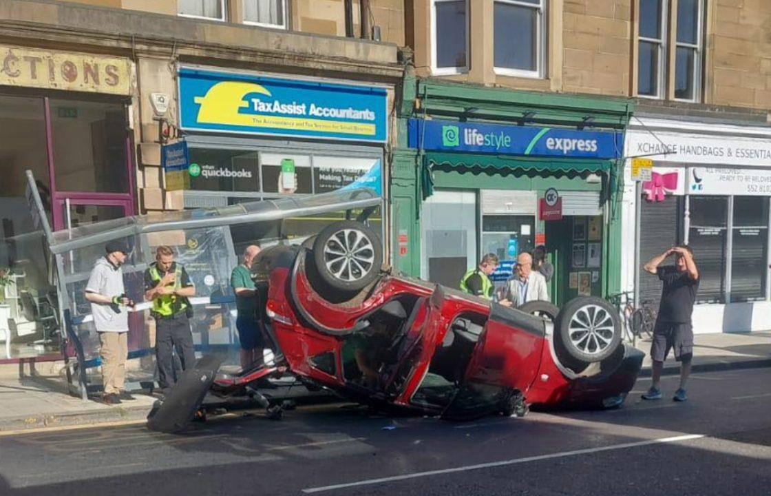 Car destroys bus stop after flipping on its roof on Edinburgh street