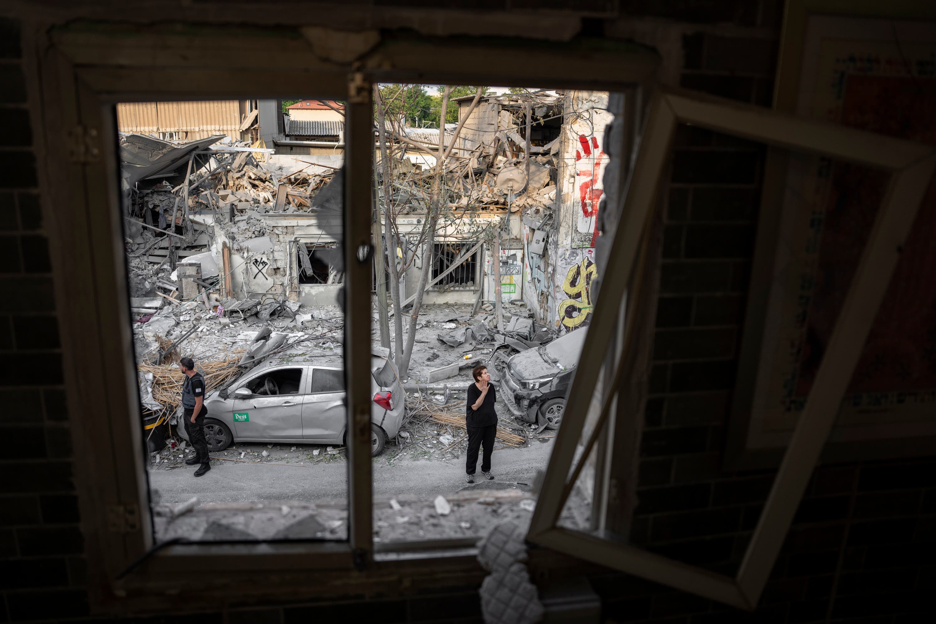 Israelis inspect the rubble of a building a day after it was hit by a rocket fired from the Gaza Strip.