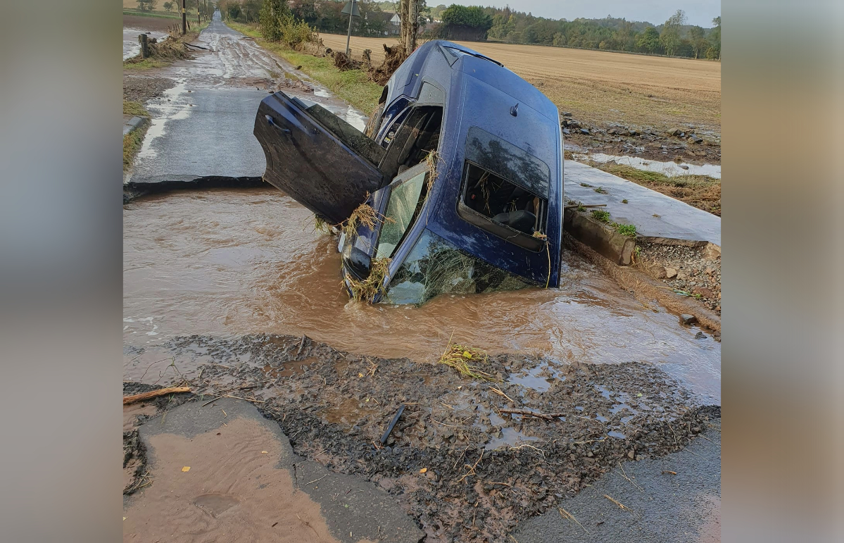 A car collapsed into part of the road washed away by Storm Babet near Longforgan.