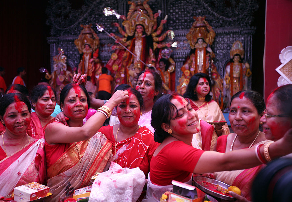 Women apply Sindoor on each other's faces during a ritual called sindoor khela on Dashimi in New Delhi, India. 