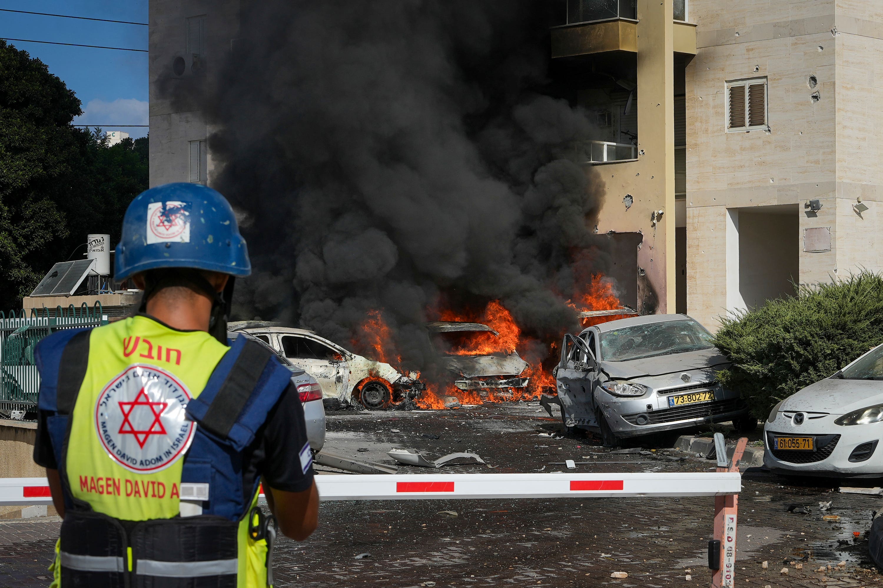 Vehicles burn after a rocket fired from the Gaza Strip hit a car park in Ashkelon, southern Israel.