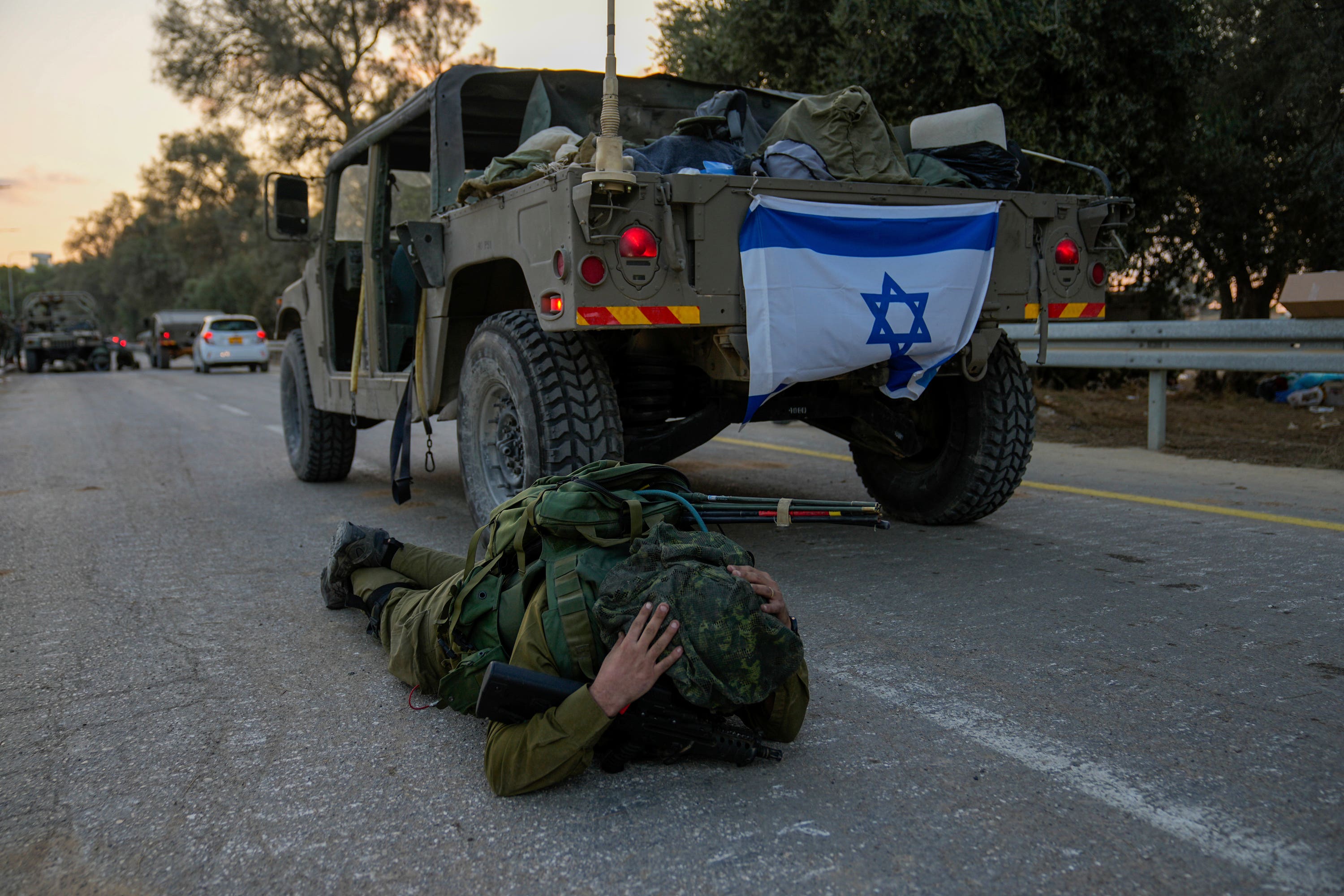 Israeli soldiers take cover on the ground. Over five days, Hamas has fired thousands of rockets into Israel.