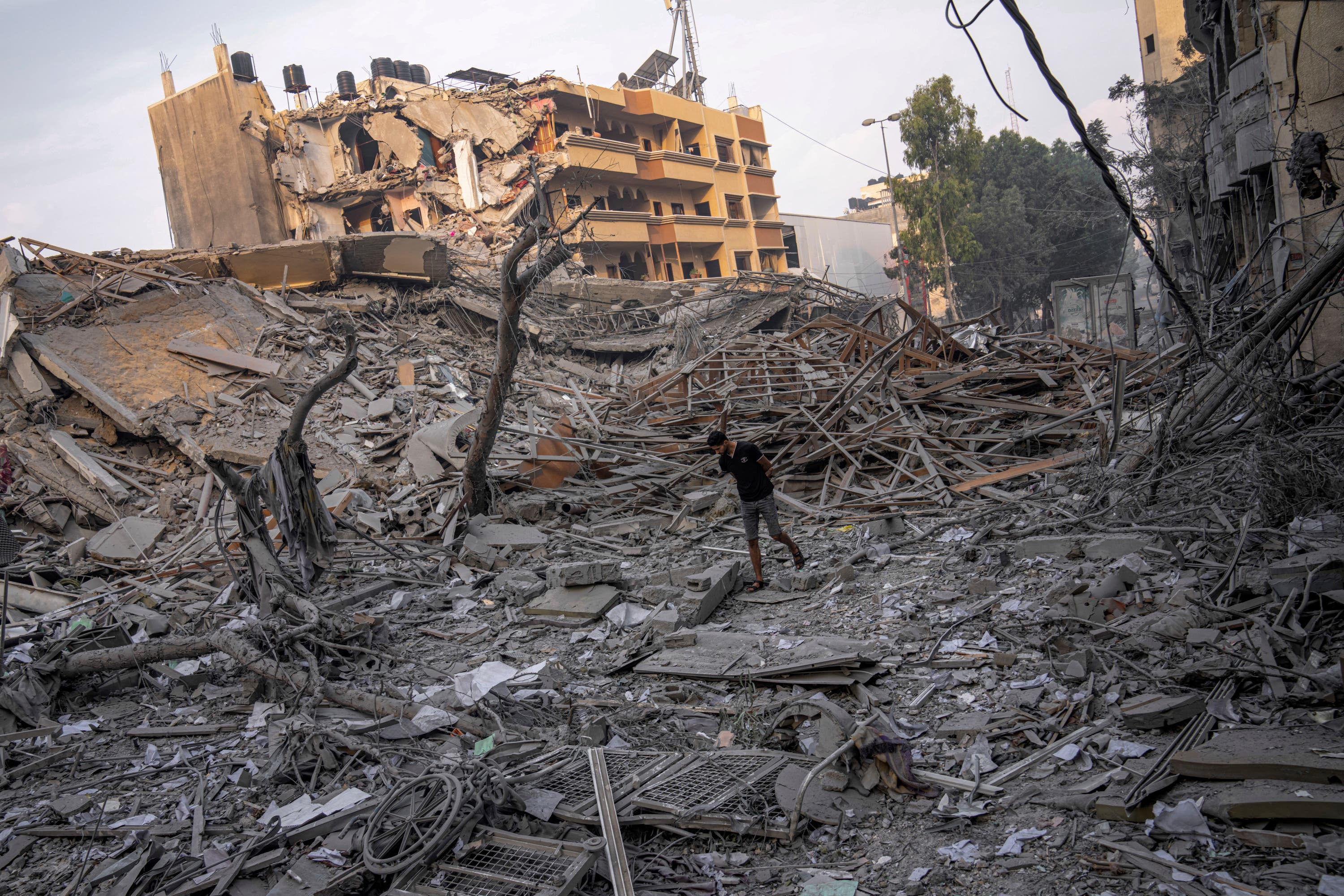 Palestinians inspect the rubble of a building after it was struck by an Israeli airstrike in Gaza City.