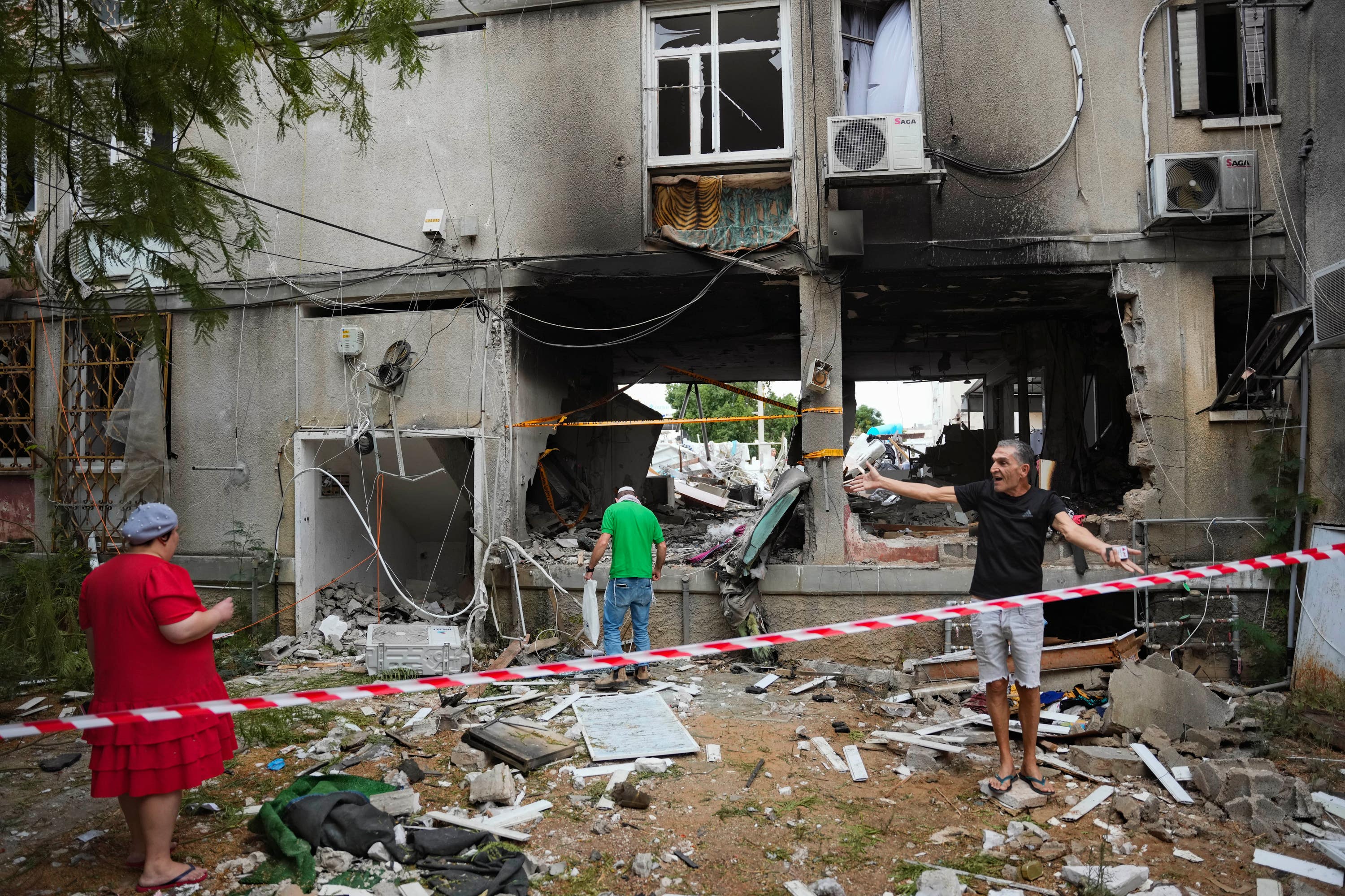 Israelis inspect a damaged residential building in Ashkelon which was hit by a rocket fired from the Gaza Strip.