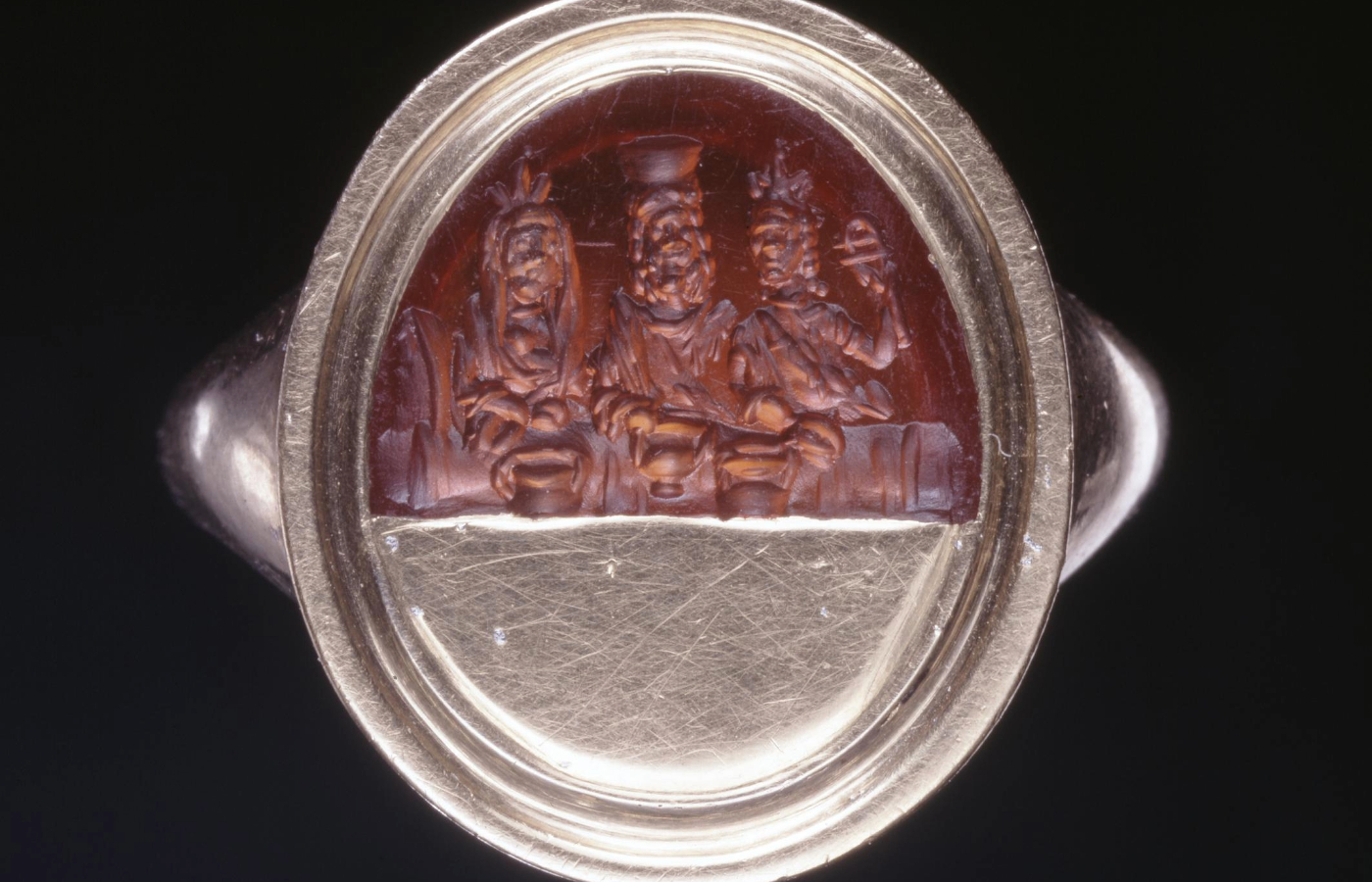 The upper part of a sard gem engraved with Sarapis wearing a calatho, 1st-3rd century AD, similar to the items missing. (The Trustees of the British Museum/PA)