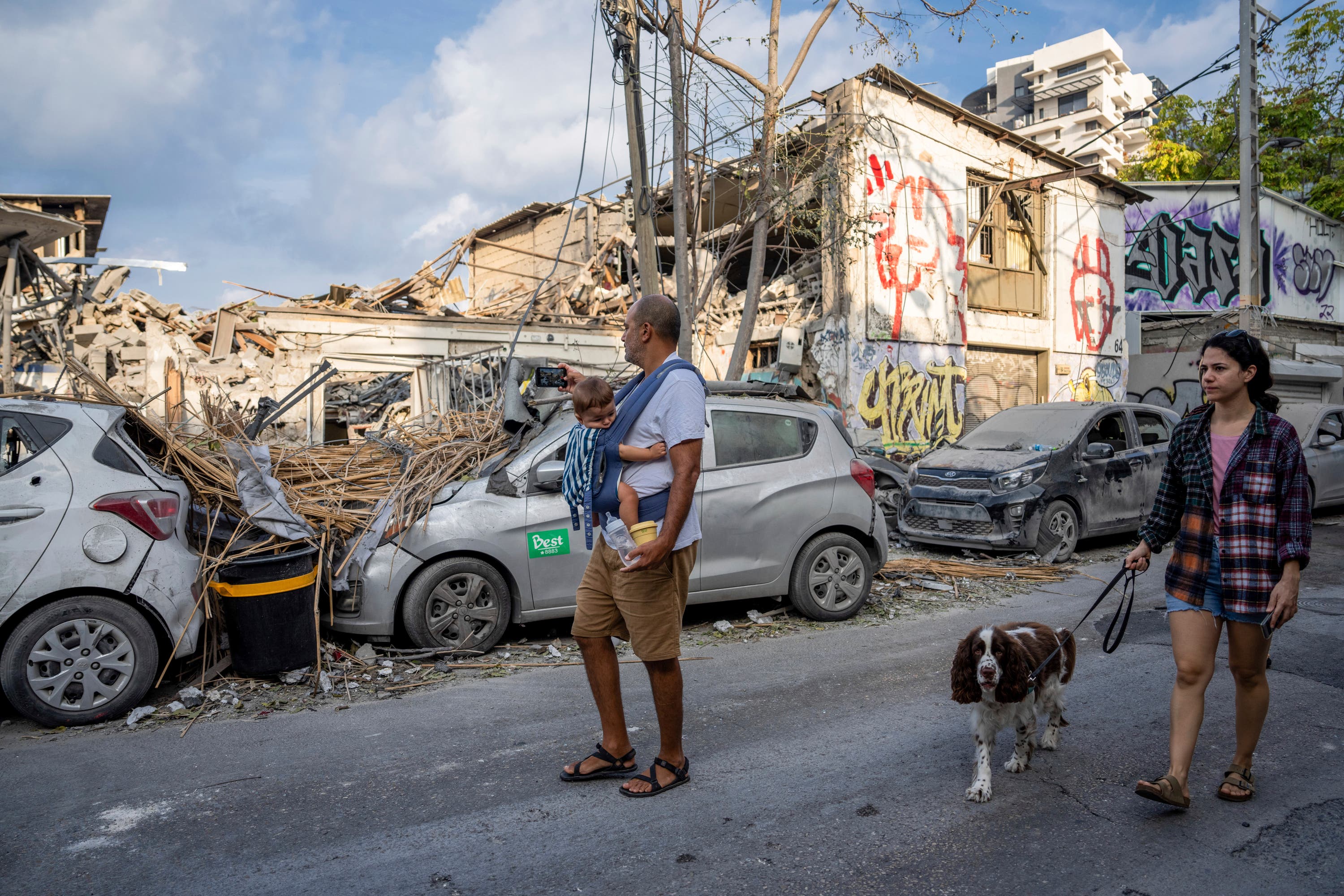 Israelis inspect the rubble of a building a day after it was hit by a rocket fired from the Gaza Strip.