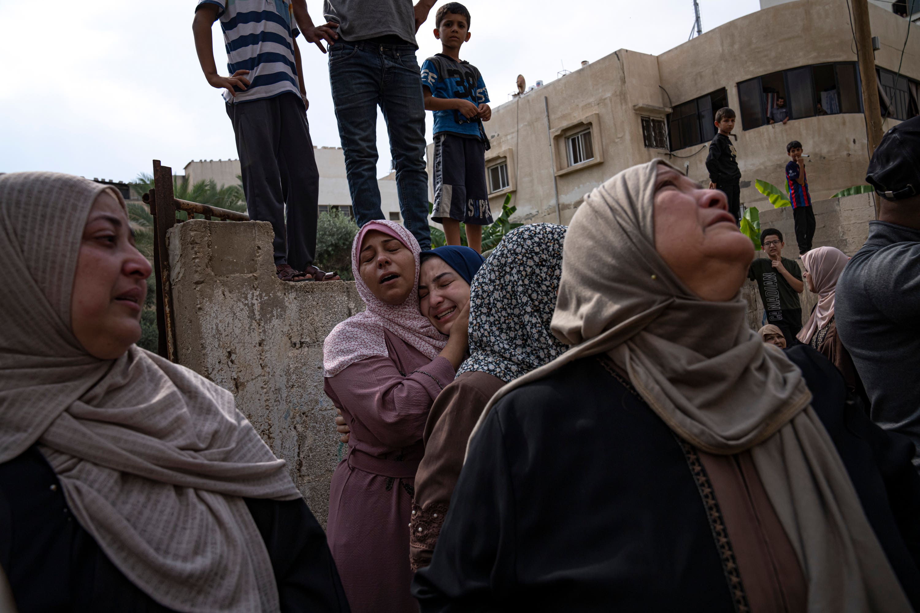 Relatives mourn people killed in an Israeli air strike in Gaza City on Monday.