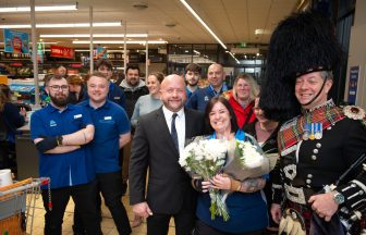 Aldi worker proposed to by store manager partner at Inverness supermarket accompanied by bagpiper