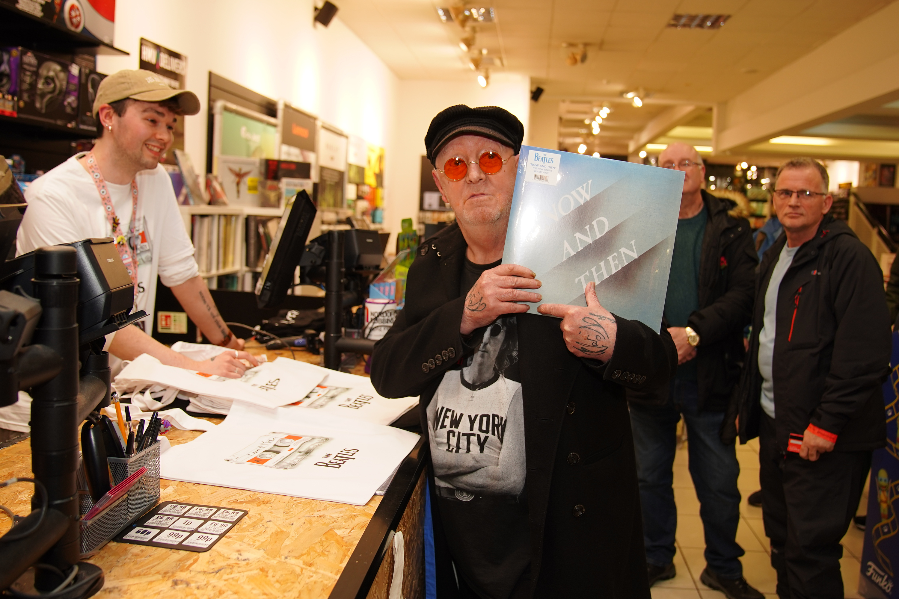 Beatles superfan John Lennon, who changed his name by deed poll from Alan Williams in 2022, holds the first copy of the newly released last Beatles song, Now And Then, at a special midnight launch event at HMV Liverpool.