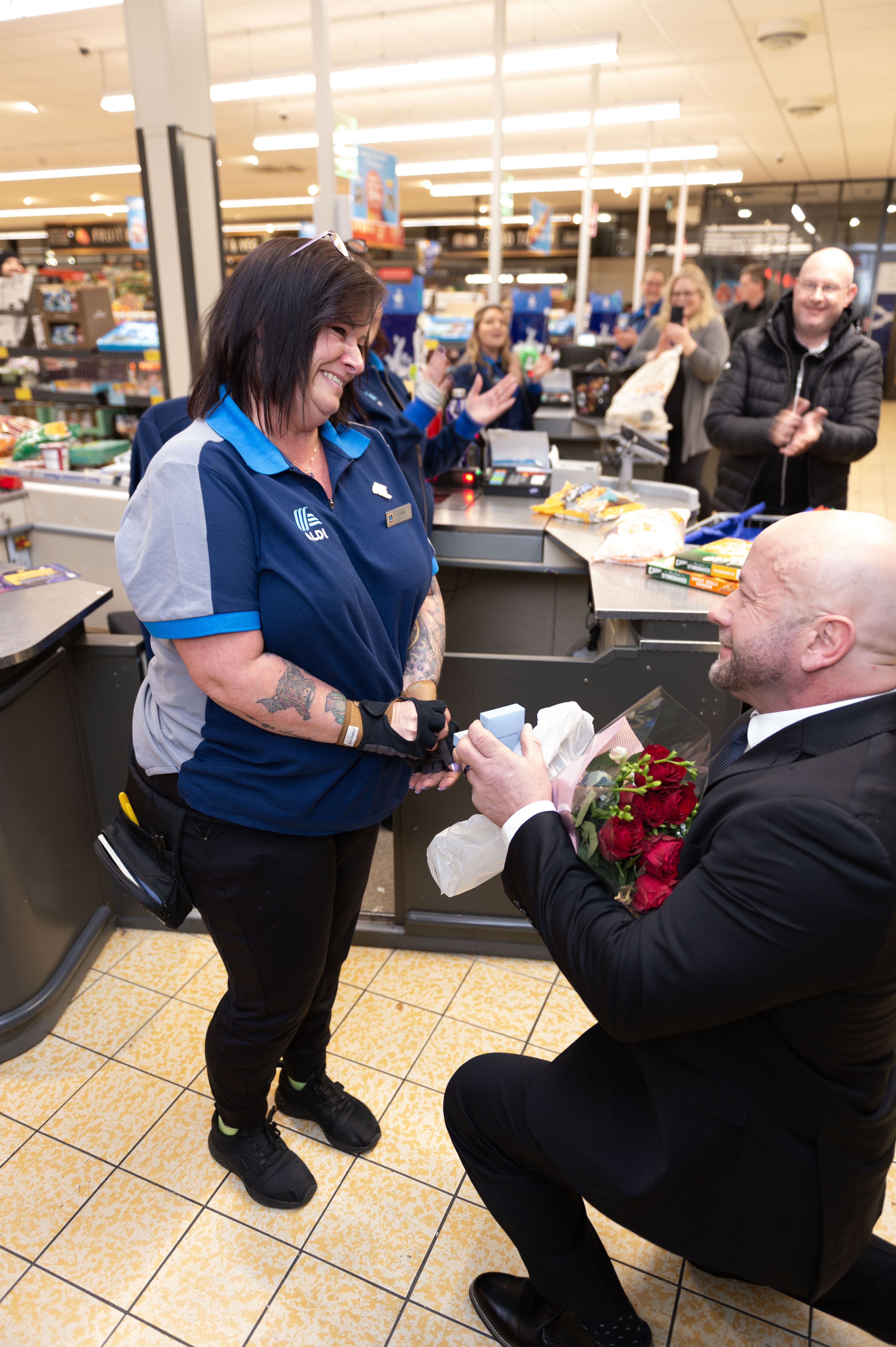 Lynne was surprised while putting through a customer's shopping as her partner proposed.
