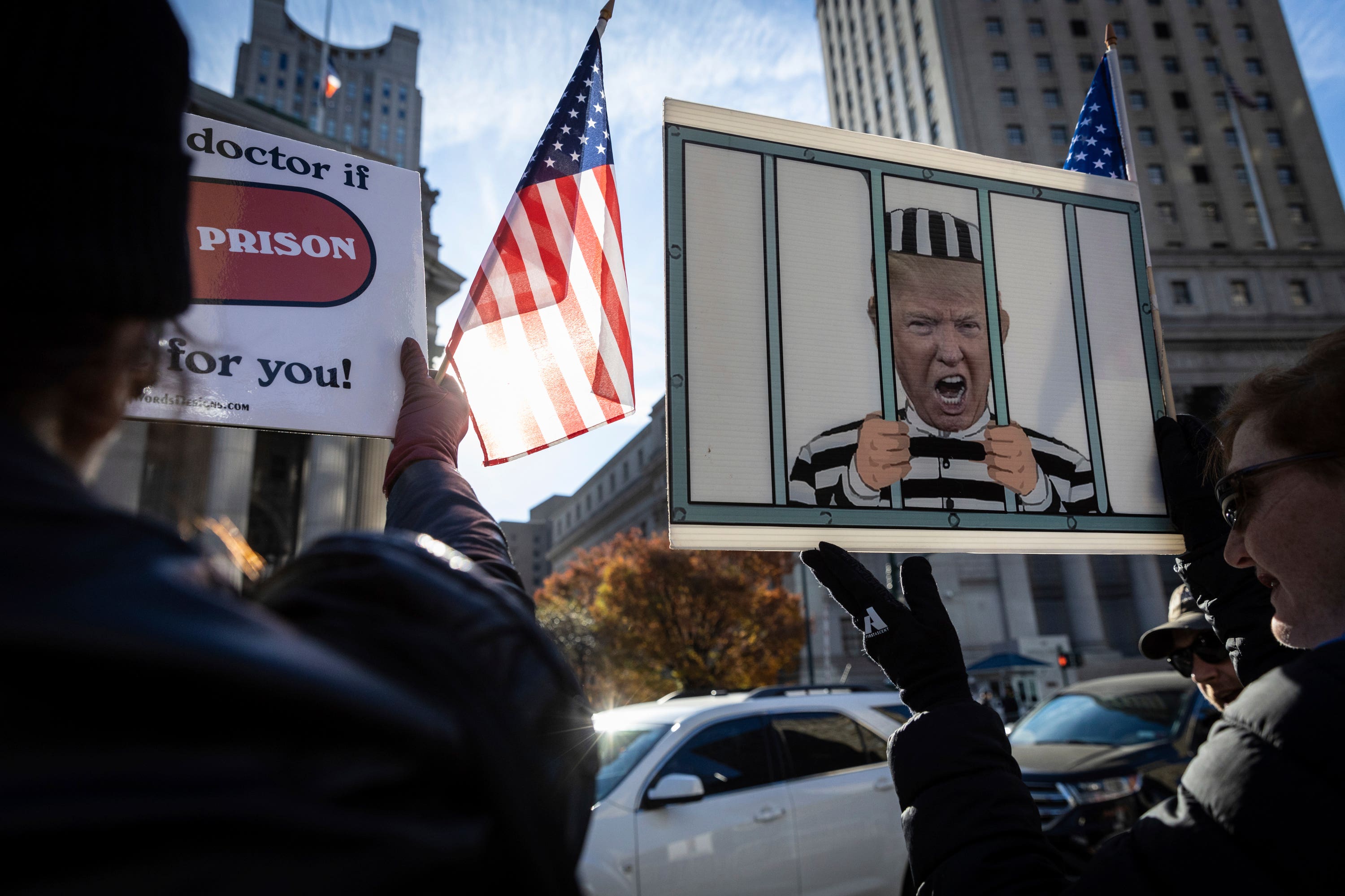 People protest against former president Donald Trump outside the New York Supreme Court.