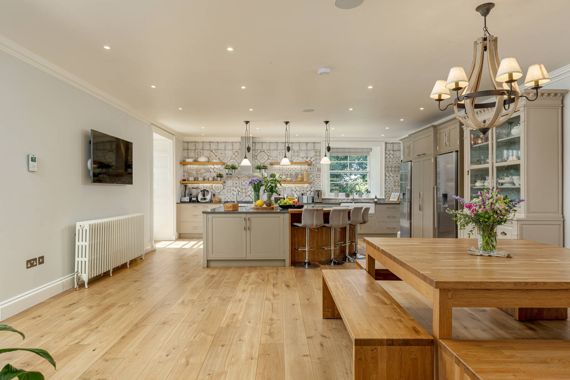 Woodhall House includes a bespoke kitchen designed and handmade by Michael Hart fitted with a large central island and high-spec appliances.