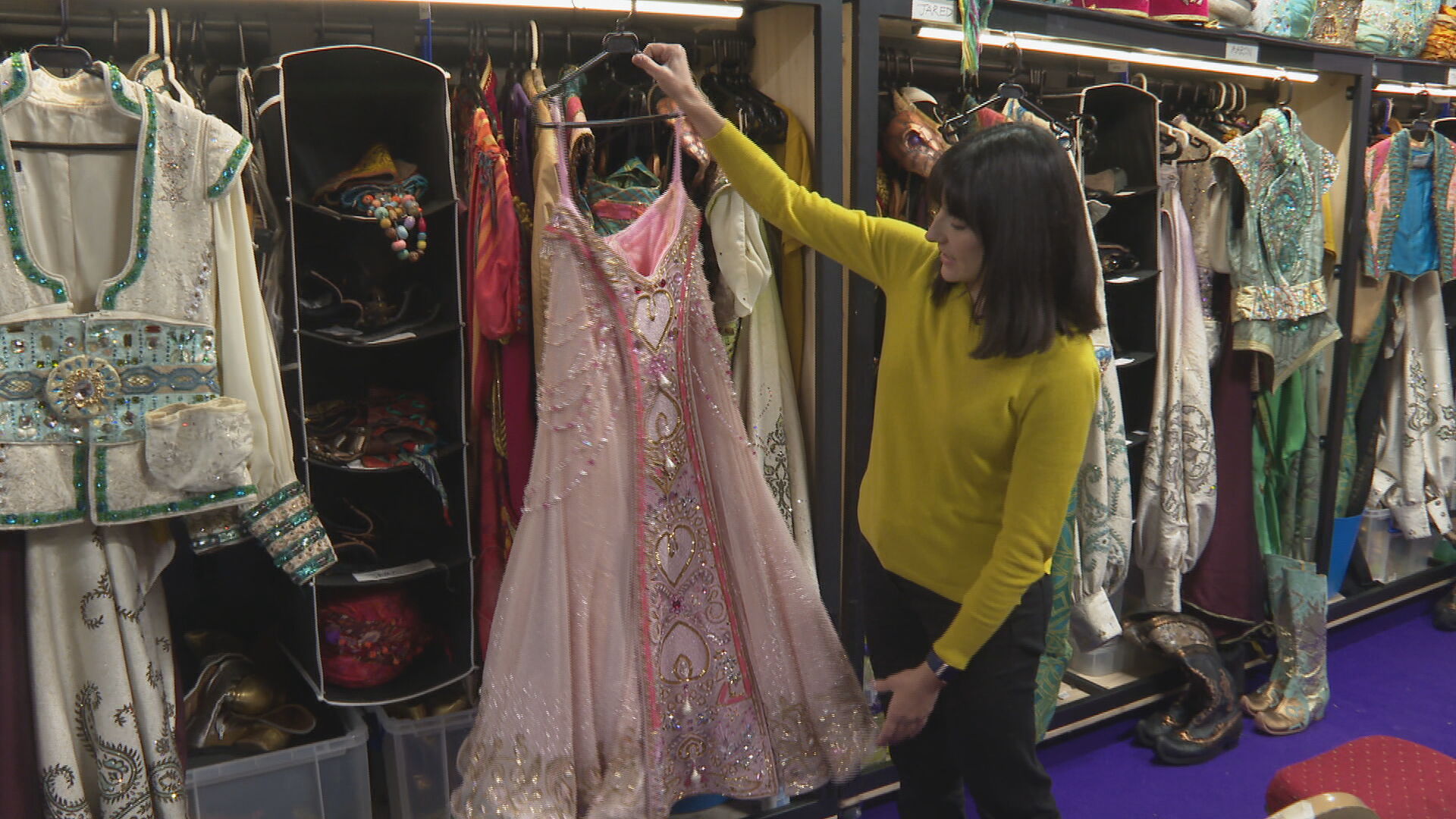 Backstage with Head of Wardrobe, Abigail Morgan, showing off the details of one of Jasmine's costumes.