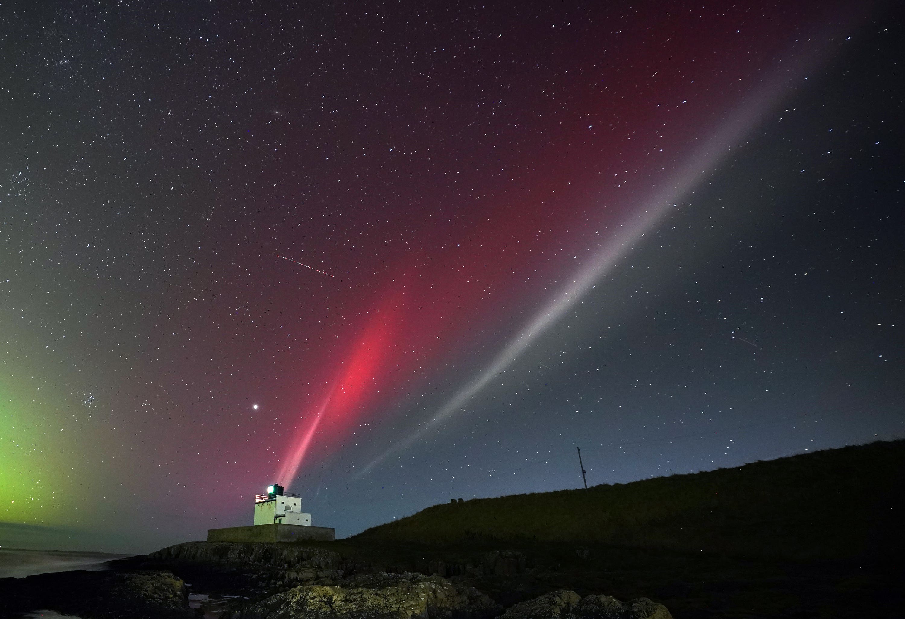 A strong thermal emission velocity enhancement, a rare aurora-like phenomenon named a STEVE in 2016 by scientists in Canada, can be seen over Bamburgh castle, in Northumberland.