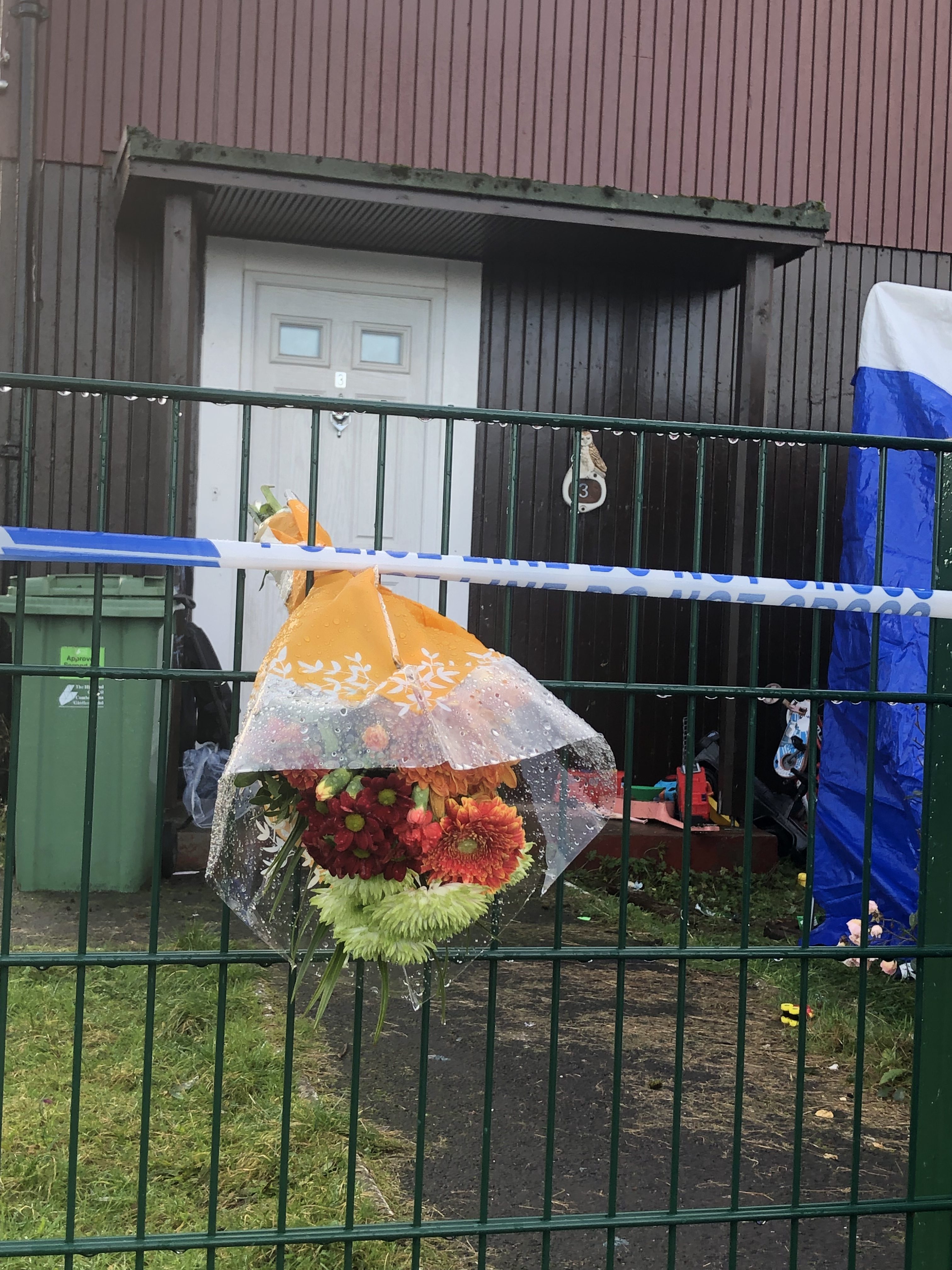 Floral tributes to the 'loving husband and doting father' have been left outside the home.