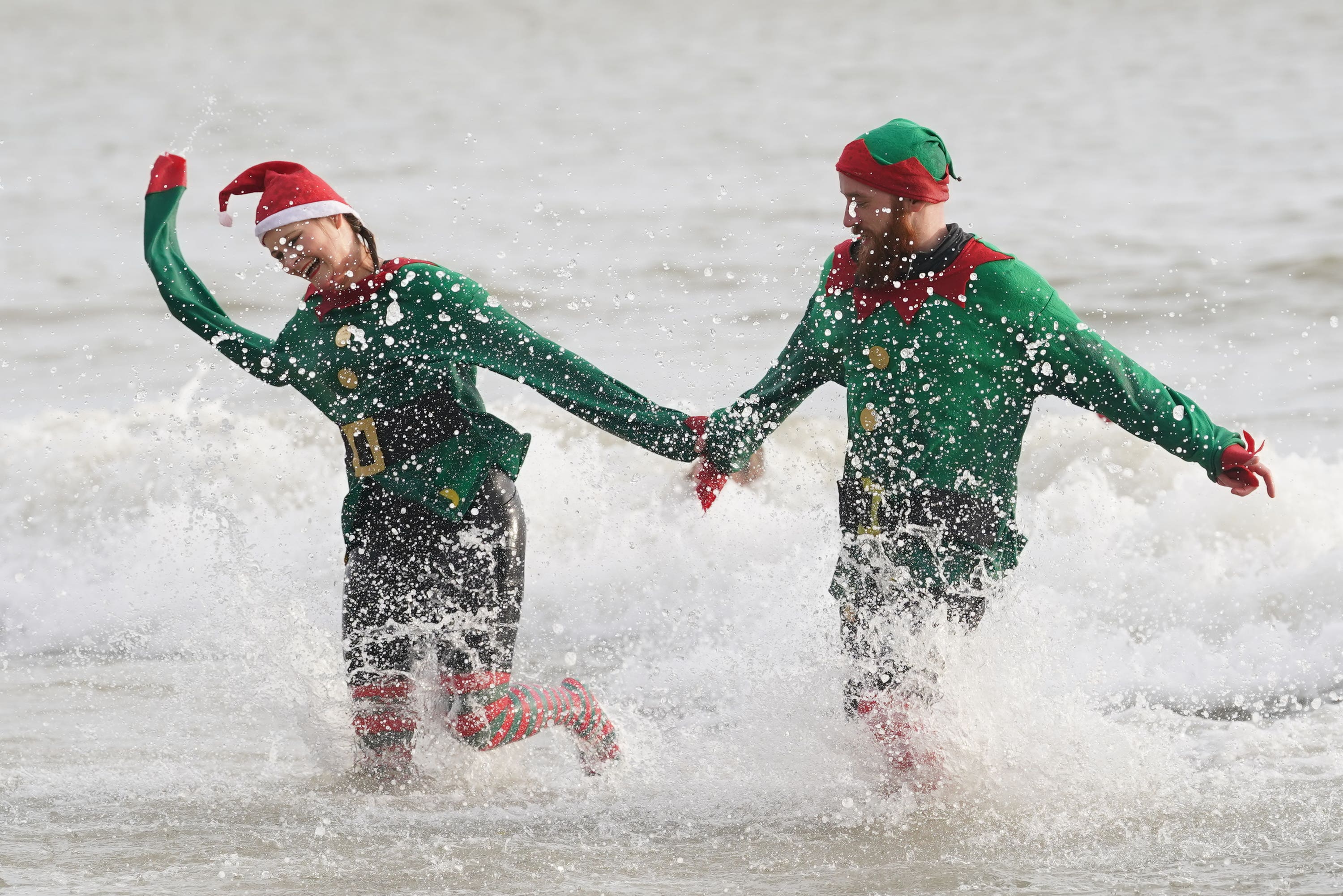 Swimmers take part in the Folkestone Lions’ Boxing Day Dip at Sunny Sands Beach in Folkestone, Kent (Gareth Fuller/PA) 
