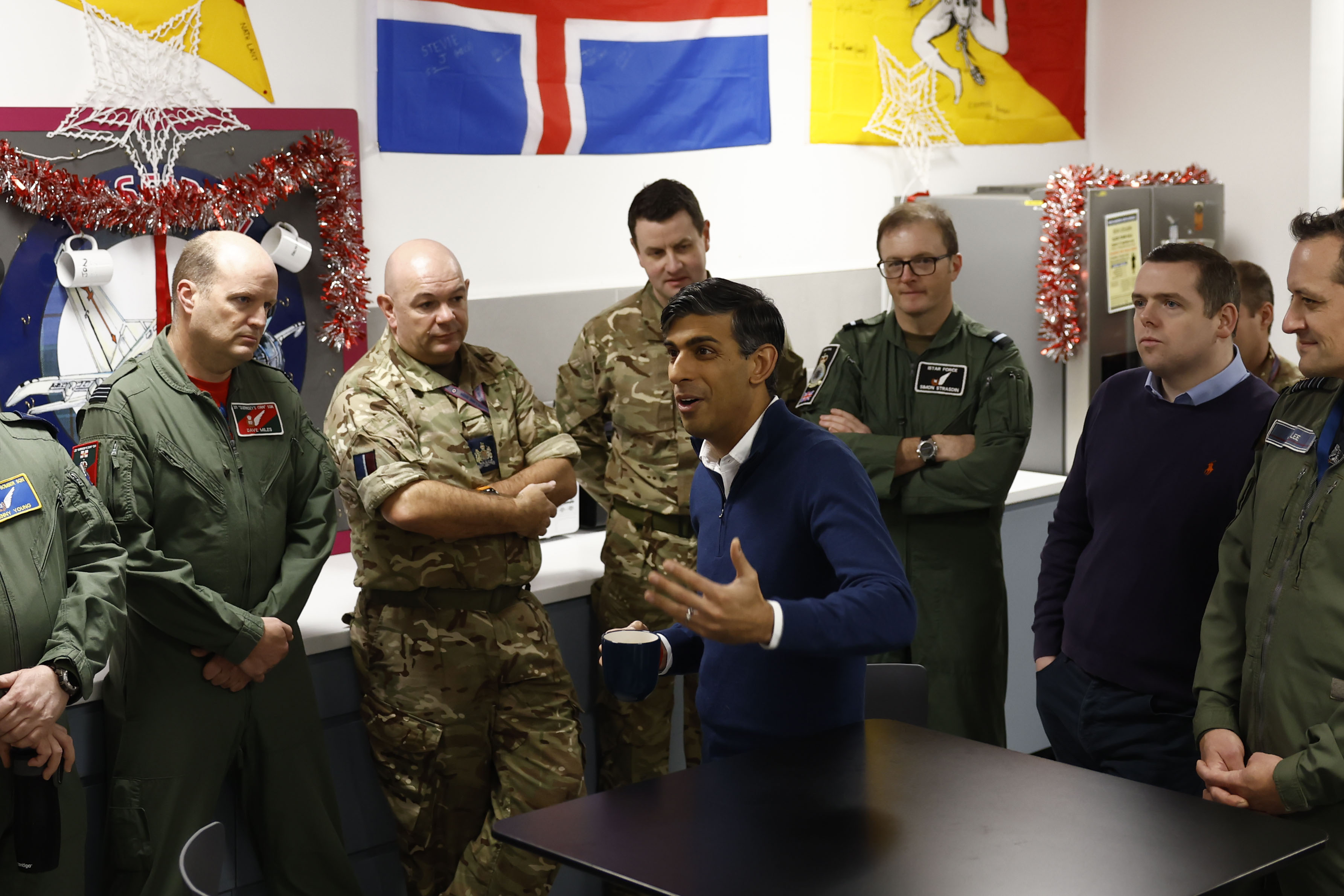 Prime Minister Rishi Sunak speaks to soldiers alongside Group captain Jim Lee (R) station commander and Scottish Conservative leader Douglas Ross (2ndR) at the RAF Lossiemouth in Moray.