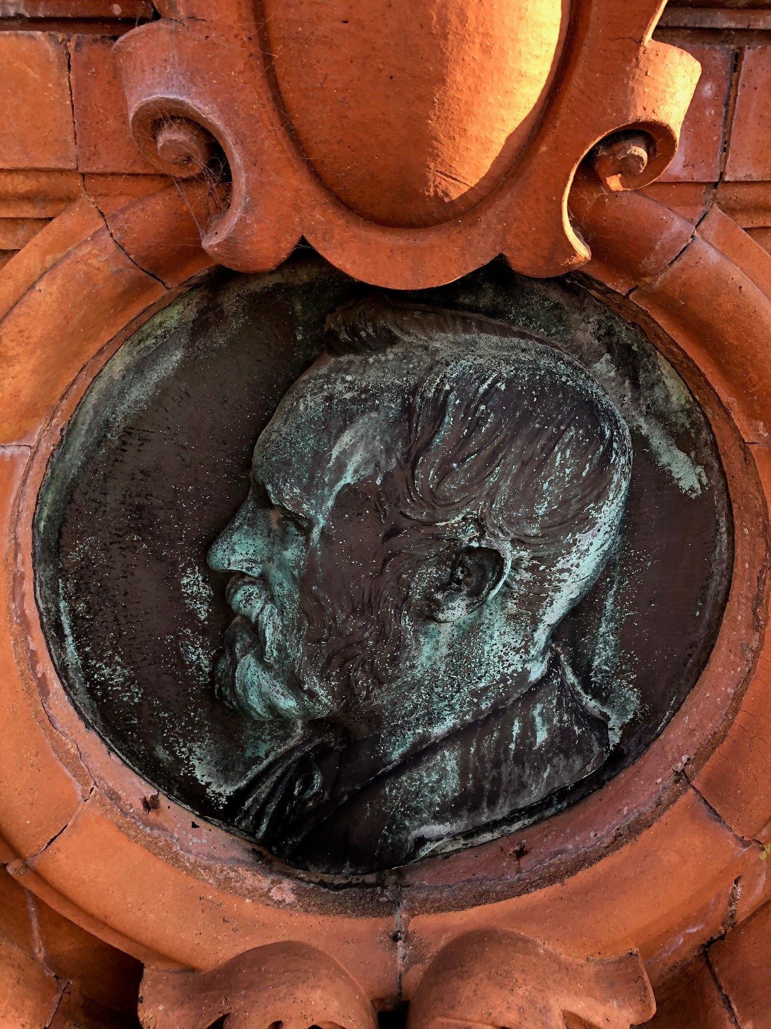 Two identical portrait medallions of Cameron by the sculptor George Tinworth are found to the north and south sides.