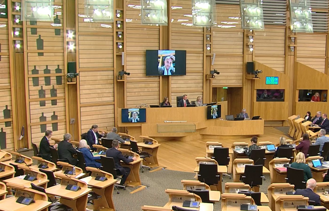 Scottish Liberal Democrat leader Alex Cole-Hamilton attempts to take part in Holyrood vote from outside the parliament's bar.