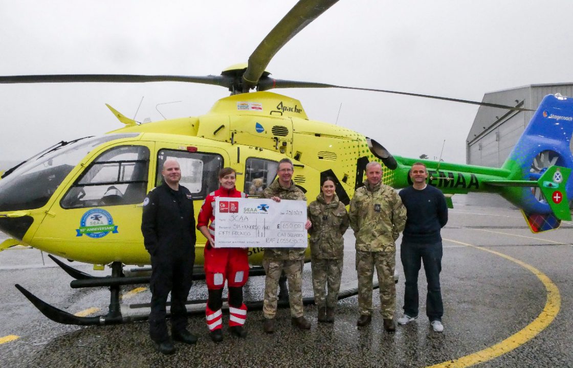 RAF officer presents fundraising cheque to Scottish Air Ambulance Charity after plane crash rescue in Elgin