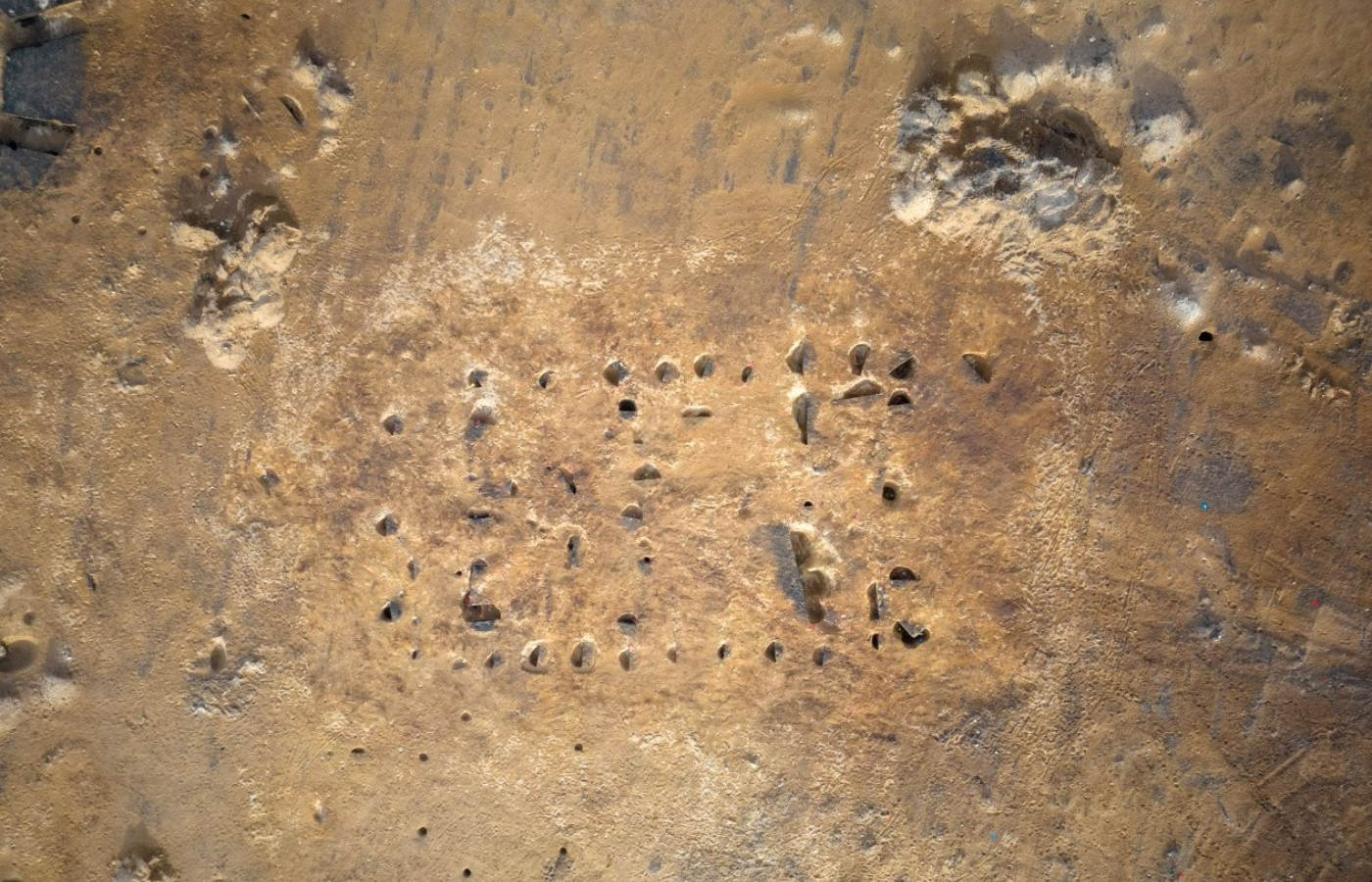 Aerial view of postholes and pits at the excavation site of a possible Neolithic timber 'hall'.