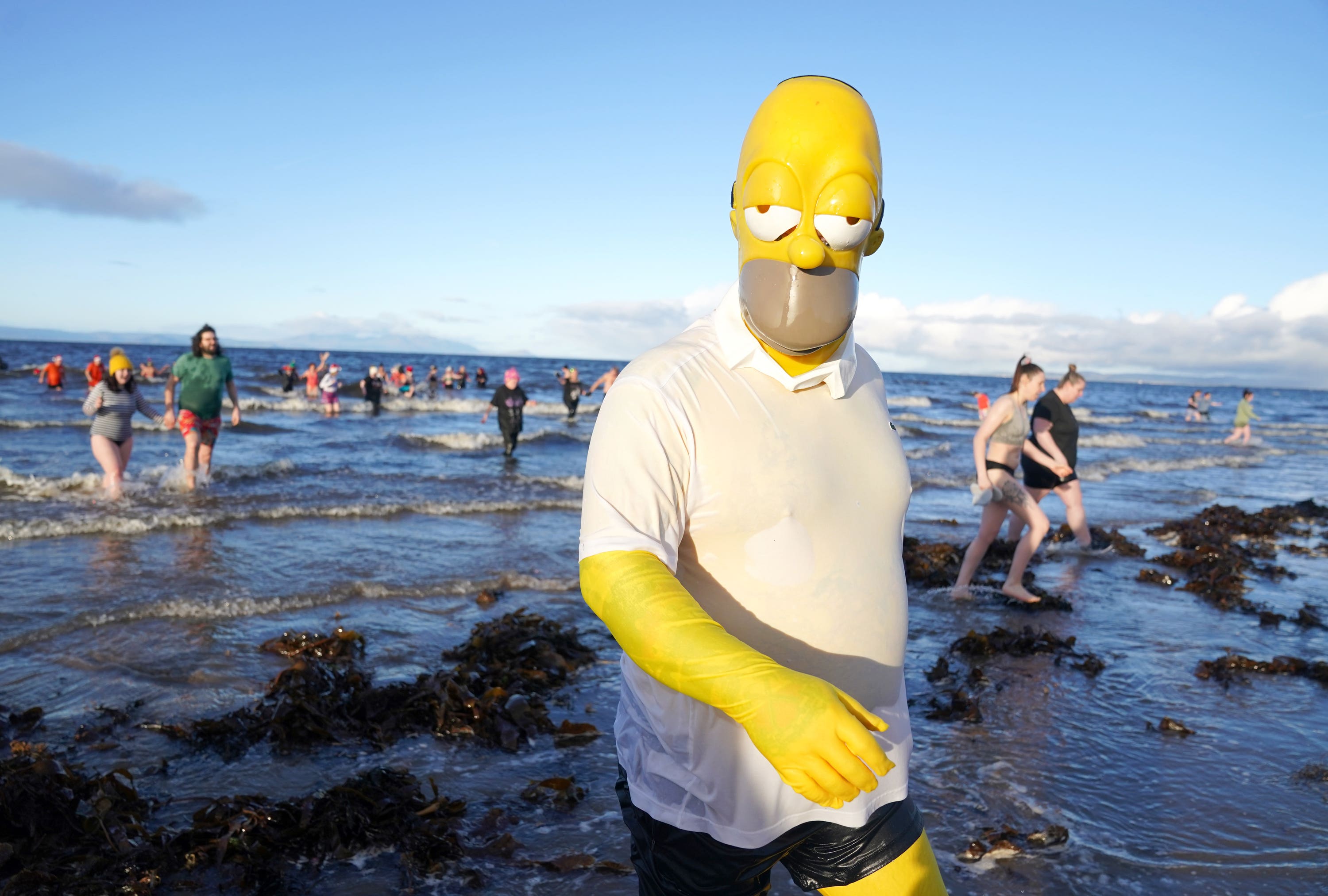 Swimmers dressed up for the Ayrshire Cancer Support Boxing Day Dip at Ayr Beach (Andrew Milligan/PA) 