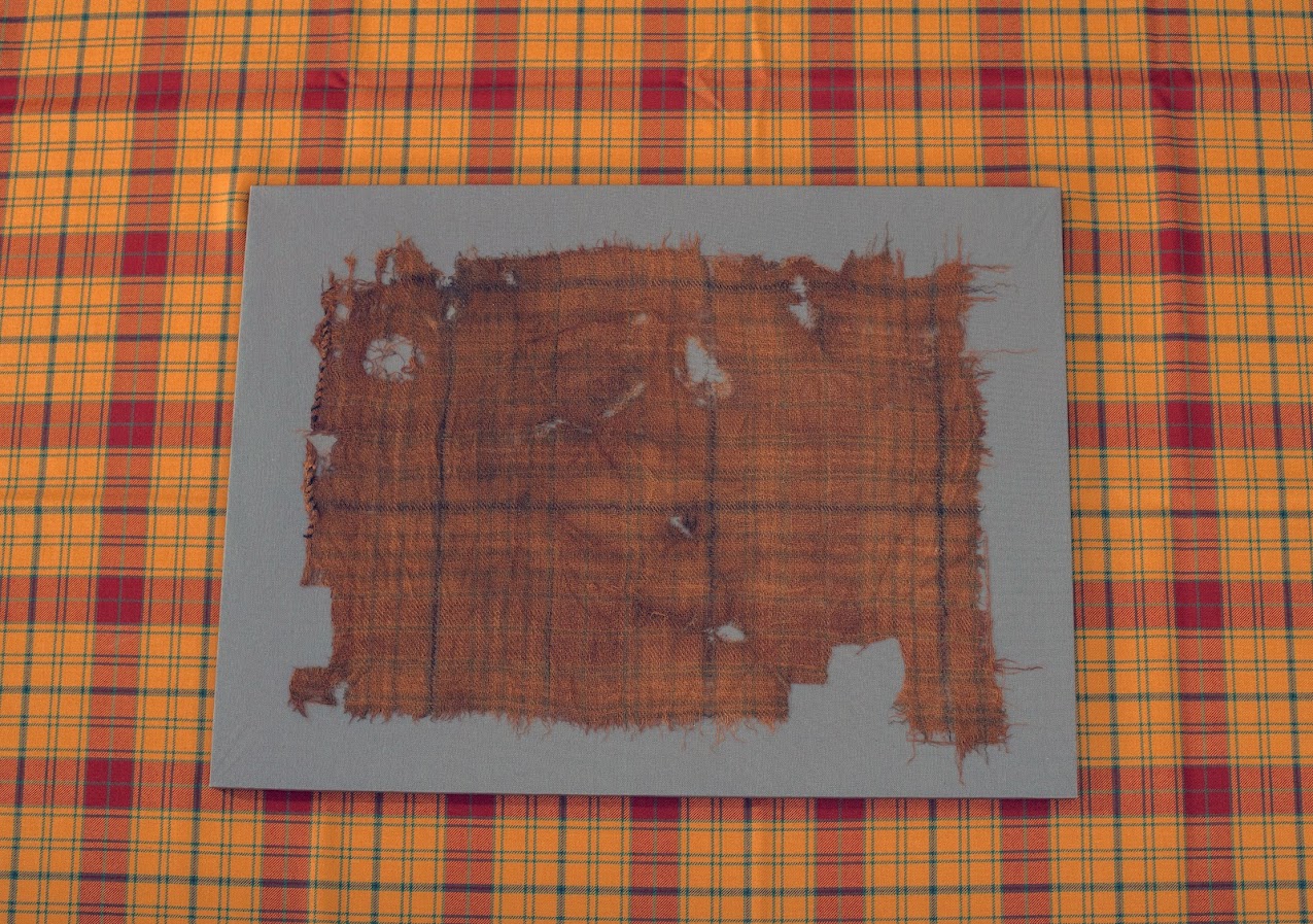 The original Glen Affric Tartan laid on top of the newly recreated tartan.