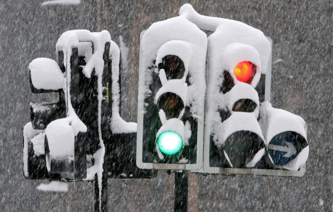 GLASGOW, UNITED KINGDOM - MARCH 12: Snow settles on traffic lights in the city after cold weather brought heavy snowfalls overnight, on March 12, 2006 in Glasgow, Scotland. Scotland?s two main airports have been forced to close and many roads are impassable. (Photo by Jeff J Mitchell/Getty Images) snow weather travel cold temperature ice
