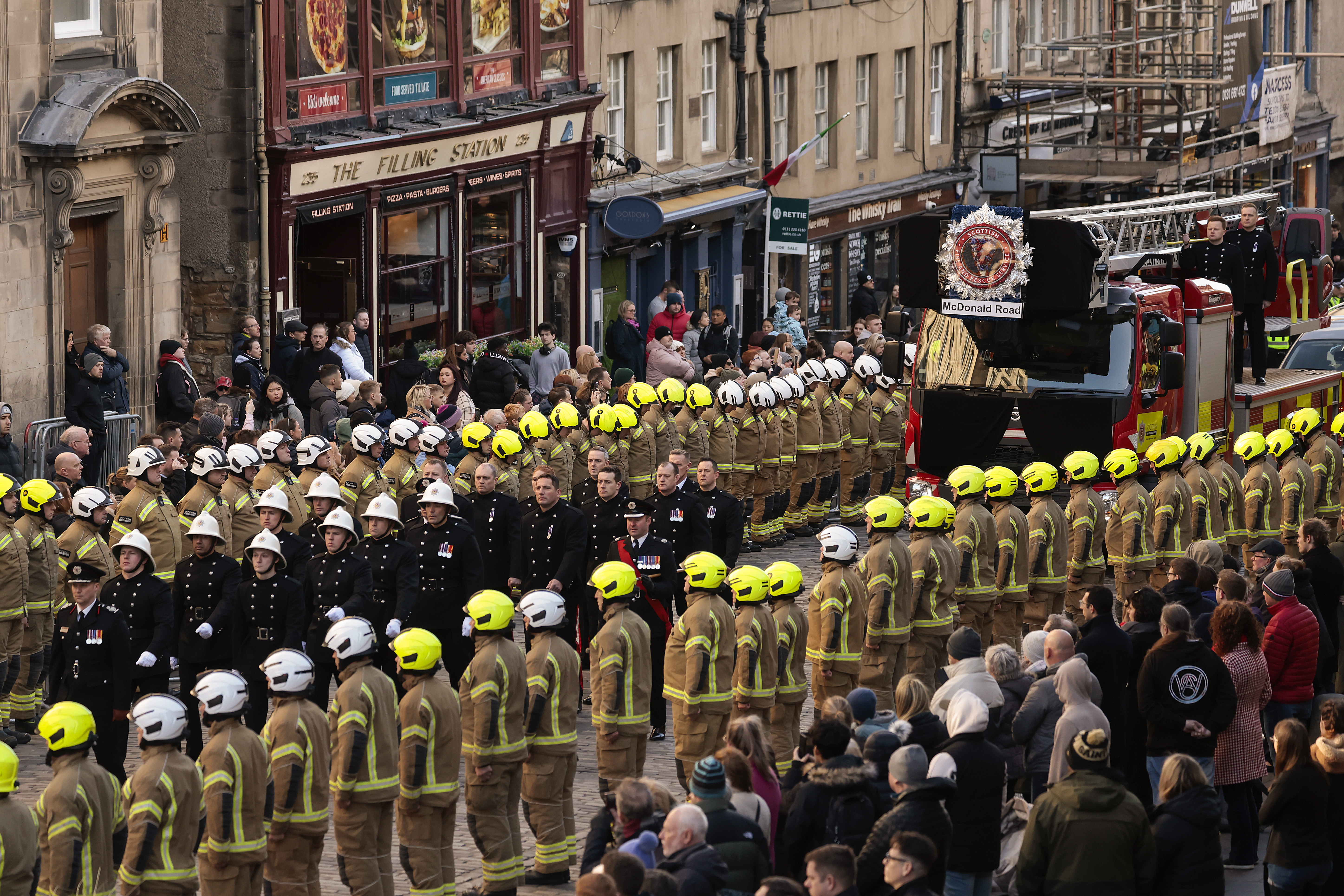 Members of the Scottish Fire and Rescue Service line the streets to pay their respects during the funeral of their colleague who died in the Jenners blaze at St Giles' Cathedral.