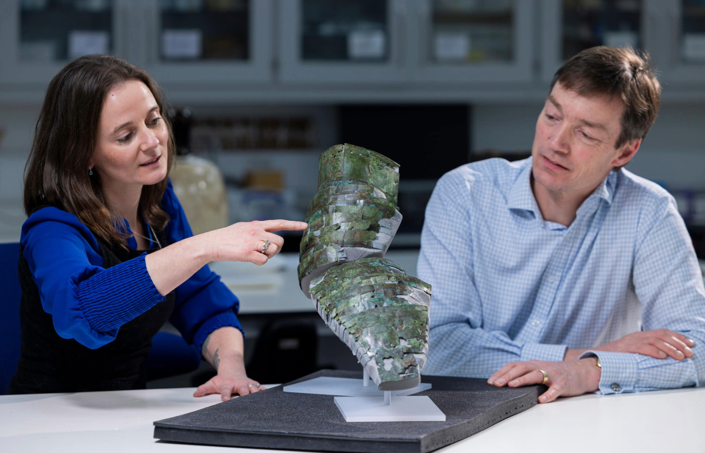 Conservator Bethan Bryan and curator Fraser Hunter with the arm guard (Duncan McGlynn/National Museums Scotland/PA).
