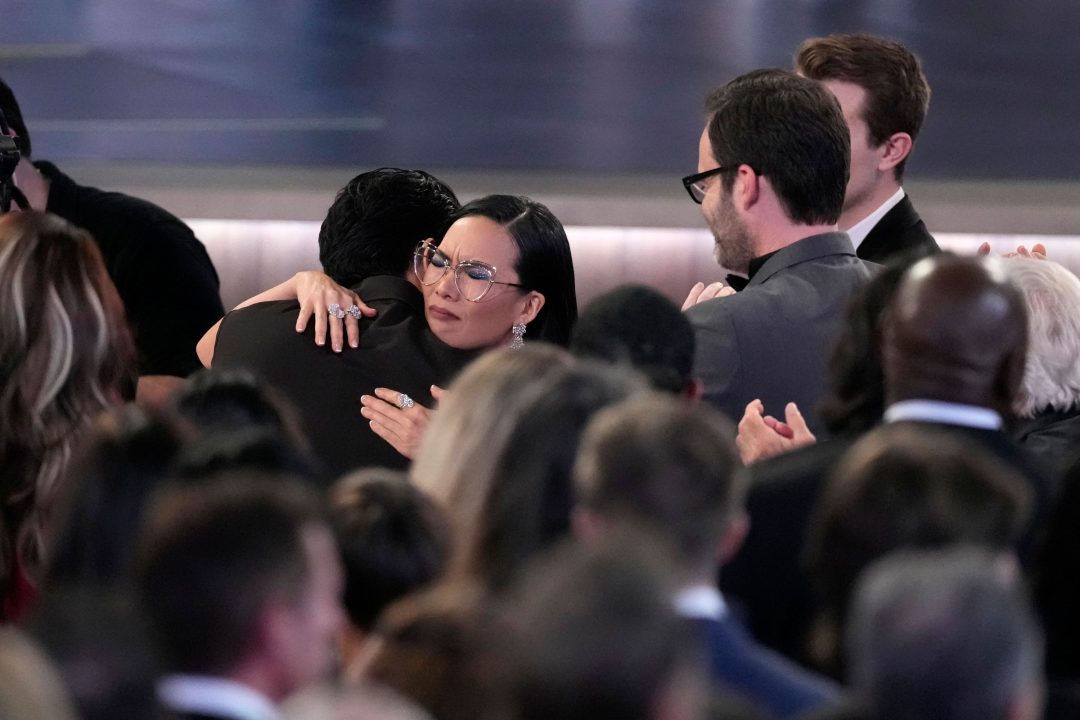 Ali Wong, left, embraces Steven Yeun after he wins the award for outstanding lead actor in a limited or anthology series or movie for Beef during the 75th Primetime Emmy Awards