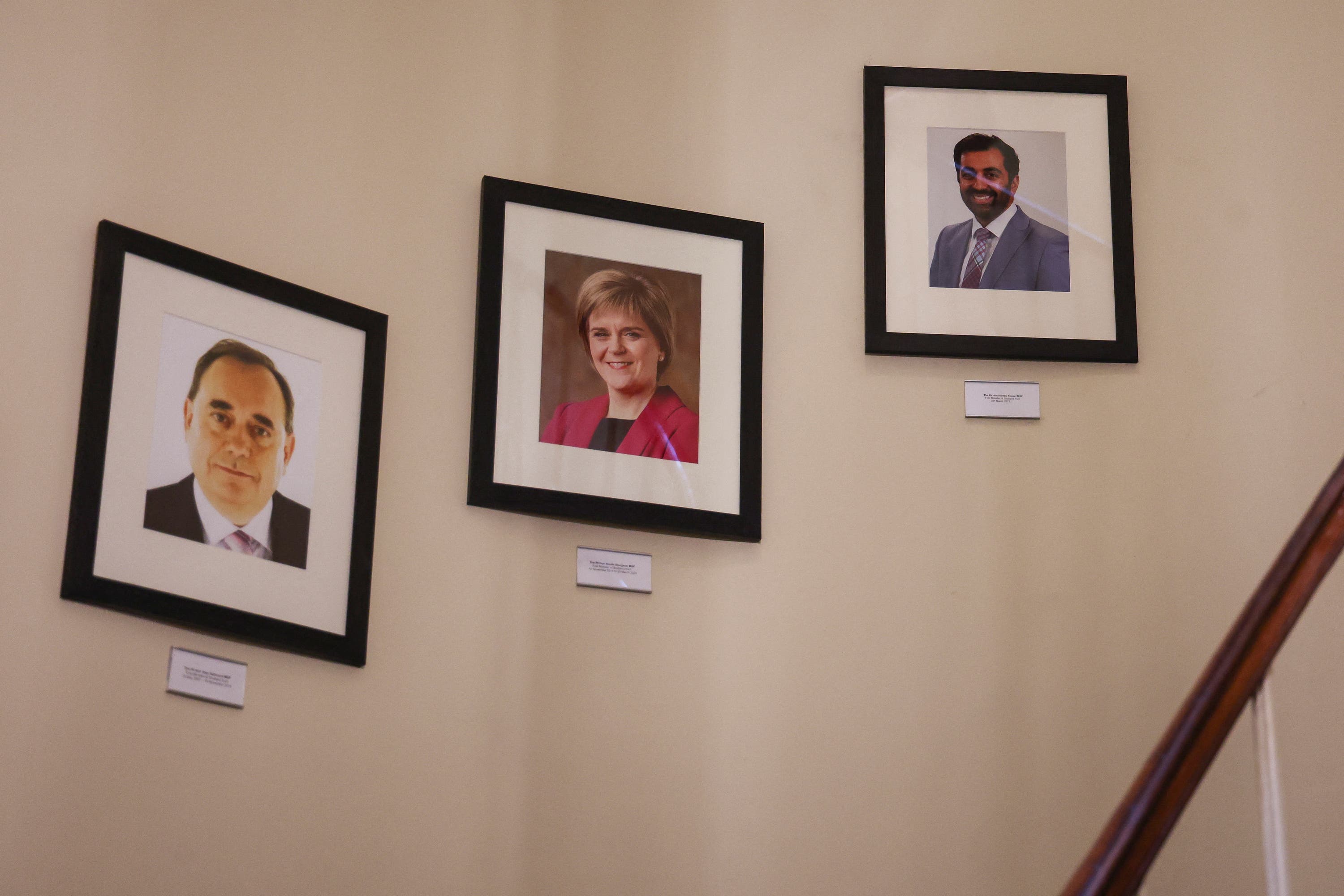 The portraits of first ministers of Scotland, left to right, Alex Salmond, Nicola Sturgeon and Humza Yousaf hanging on the wall at Bute House in Edinburgh.