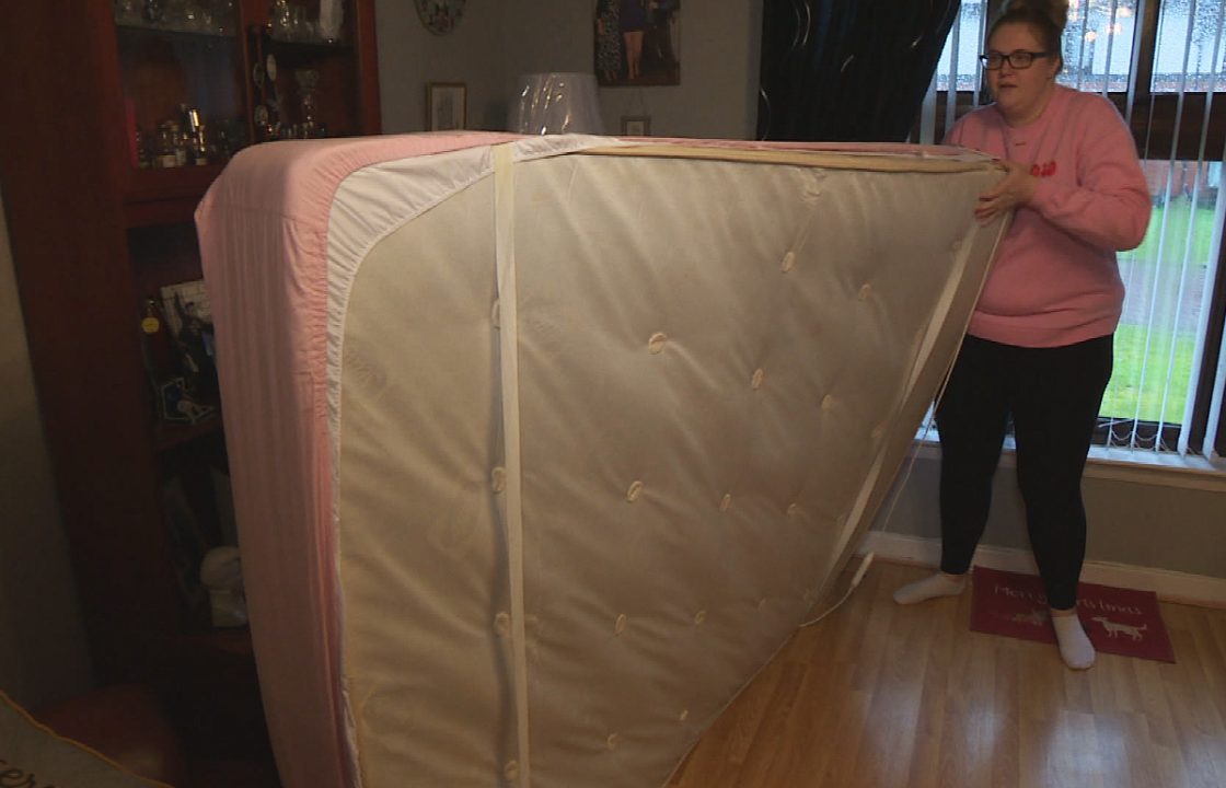 Woman sleeps on mattress in living room every night as family home