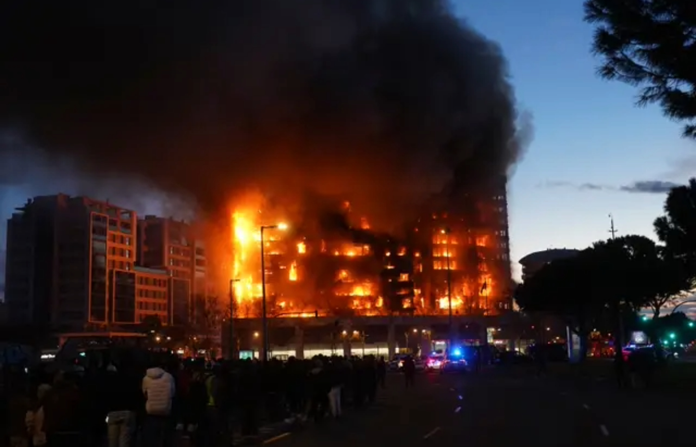 The fire began in the early evening and spread to an adjacent building, state news agency Efe reported. Photo: Alberto<em> </em>Saiz/AP.”/><cite class=cite>Alberto Saiz/AP</cite></div><figcaption aria-hidden=true>The fire began in the early evening and spread to an adjacent building, state news agency Efe reported. Photo: Alberto<em> </em>Saiz/AP. <cite class=hidden>Alberto Saiz/AP</cite></figcaption></figure><p>The fire sent clouds of black smoke billowing skywards that could be seen from afar. Spain’s weather agency, Aemet, reported winds of up to 40mph at the time.</p><p>The fire began in the early evening and spread to an adjacent building, state news agency Efe reported.</p><p>Initial emergency service reports said there were at least 13 people injured with fractures, burns and smoke inhalation. The 13 included six firefighters.</p><p>Spanish Prime Minister Pedro Sanchez posted on X saying he was “shocked by the terrible fire in a building in Valencia” adding that he had offered the city “all the help that is necessary”.</p><p>“I want to convey my solidarity to all the people affected and recognition to all the emergency personnel already deployed at the scene,” Mr Sanchez said.</p><div class=