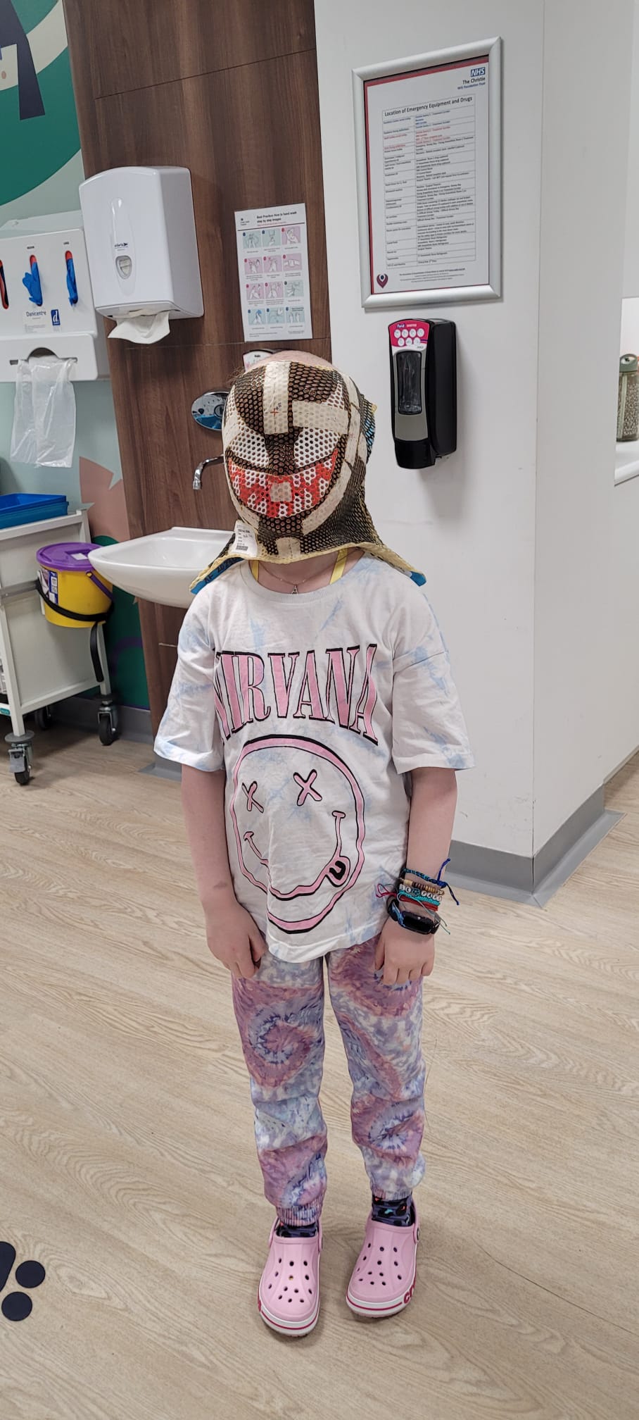 Aurora Farren, eight, wearing the radiotherapy mask she painted like the Marvel character Venom.
