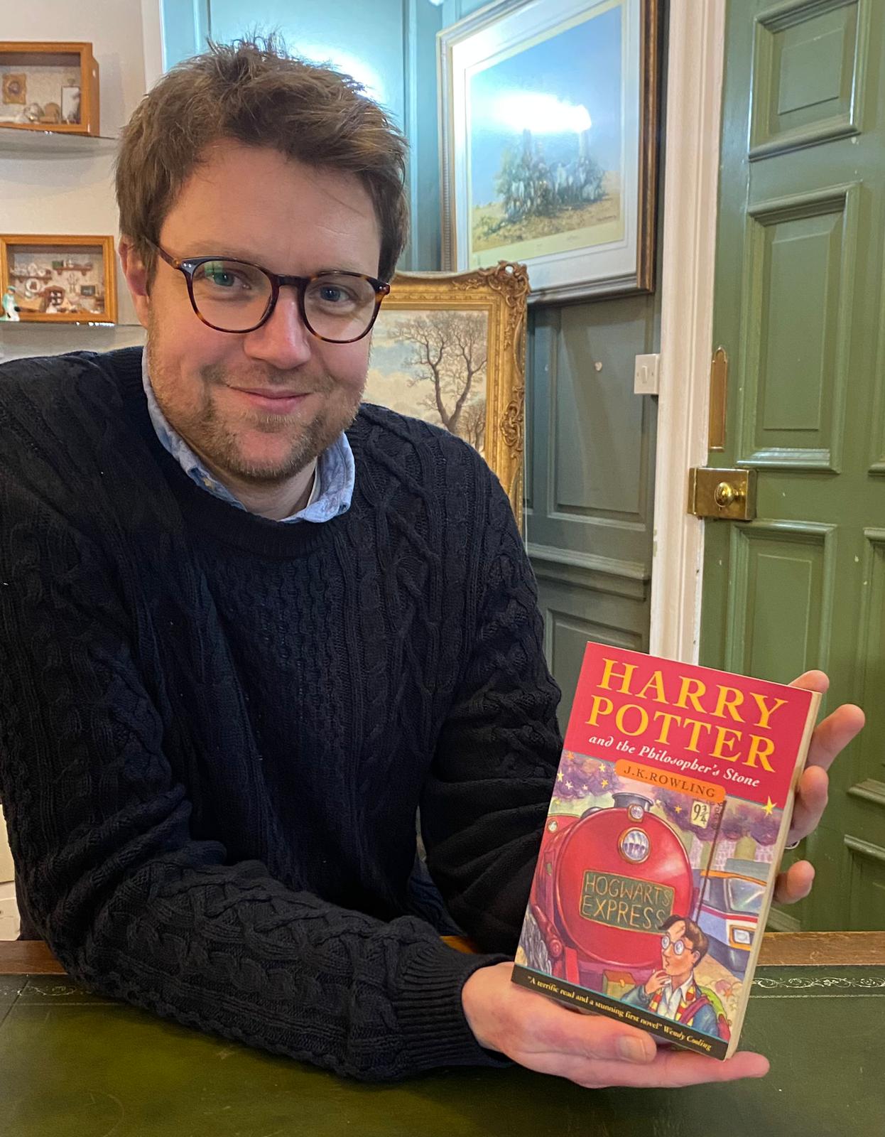 Hansons books expert Jim Spencer with the Harry Potter first edition (Hansons/PA) 