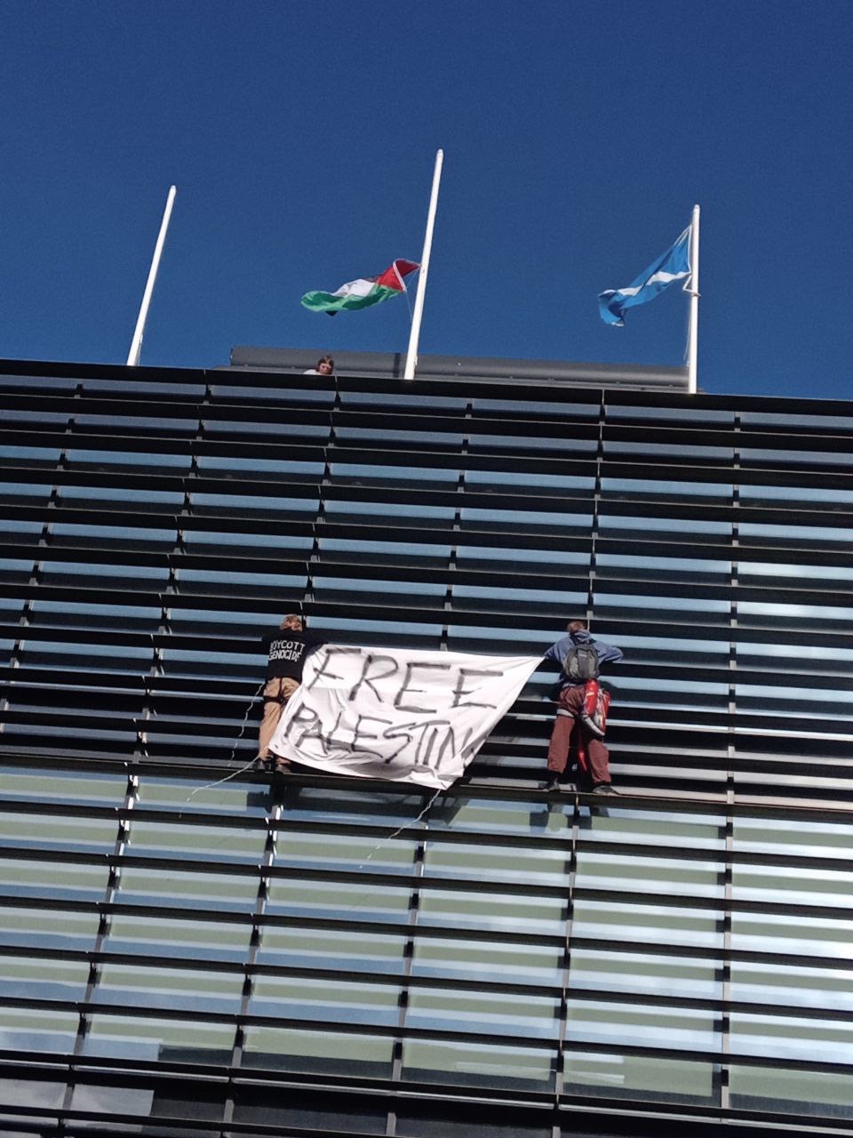 Activists unfurled a Palestinian flag on the roof of the UK Government building (This Is Rigged/PA).