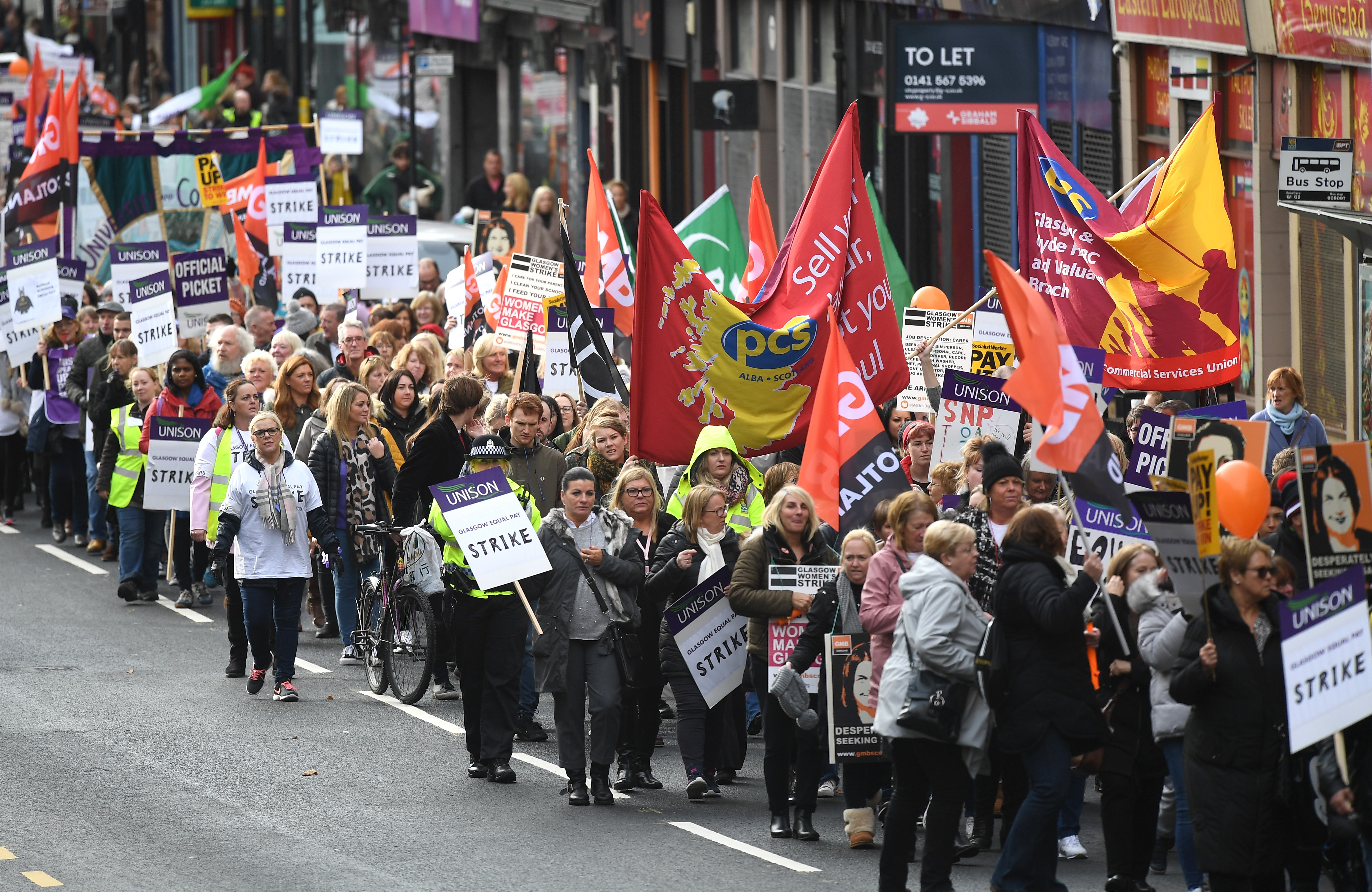 Glasgow October 23:  Demonstrators hold placards as they march for equal pay for Glasgow council workers on October 23, 2018 in Glasgow. An estimated 8,000 workers joined a 48-hour walkout, aimed at spurring the settlement of equal-pay claims from thousands of female workers.  (Photo by Jeff J Mitchell/Getty Images)