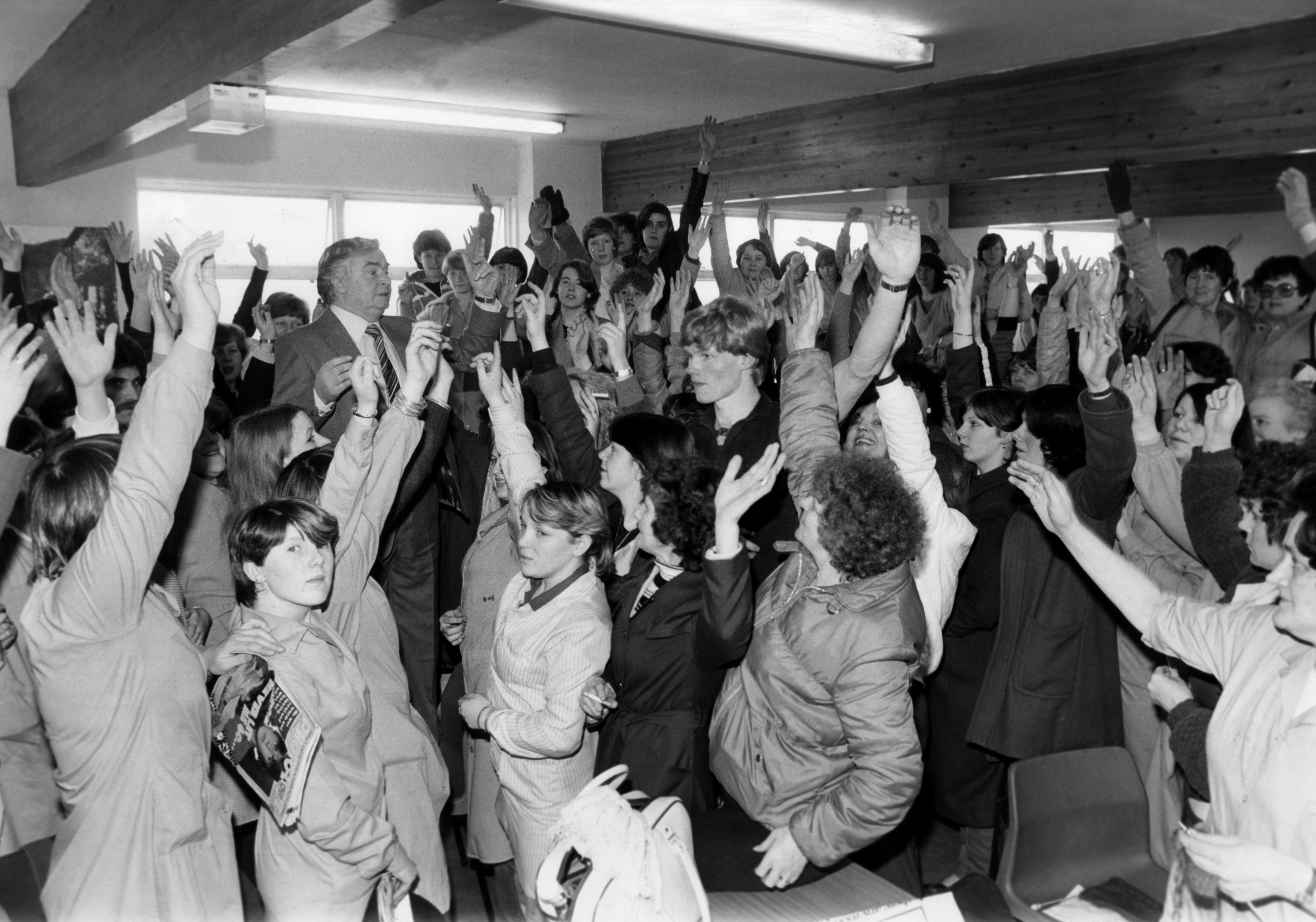 More than 200 women unanimously voted to continue their sit-in at Lee Leisurewear, Larkfield Estate, Greenock, February 9 1981. The women, and their male colleagues, started the sit-in last week after their American bosses said the factory was to close. David Wales, a member of the union's national executive, visited the sit-in and was given overwhelming backing to continue the fight. (Photo by Mirrorpix/Getty Images)