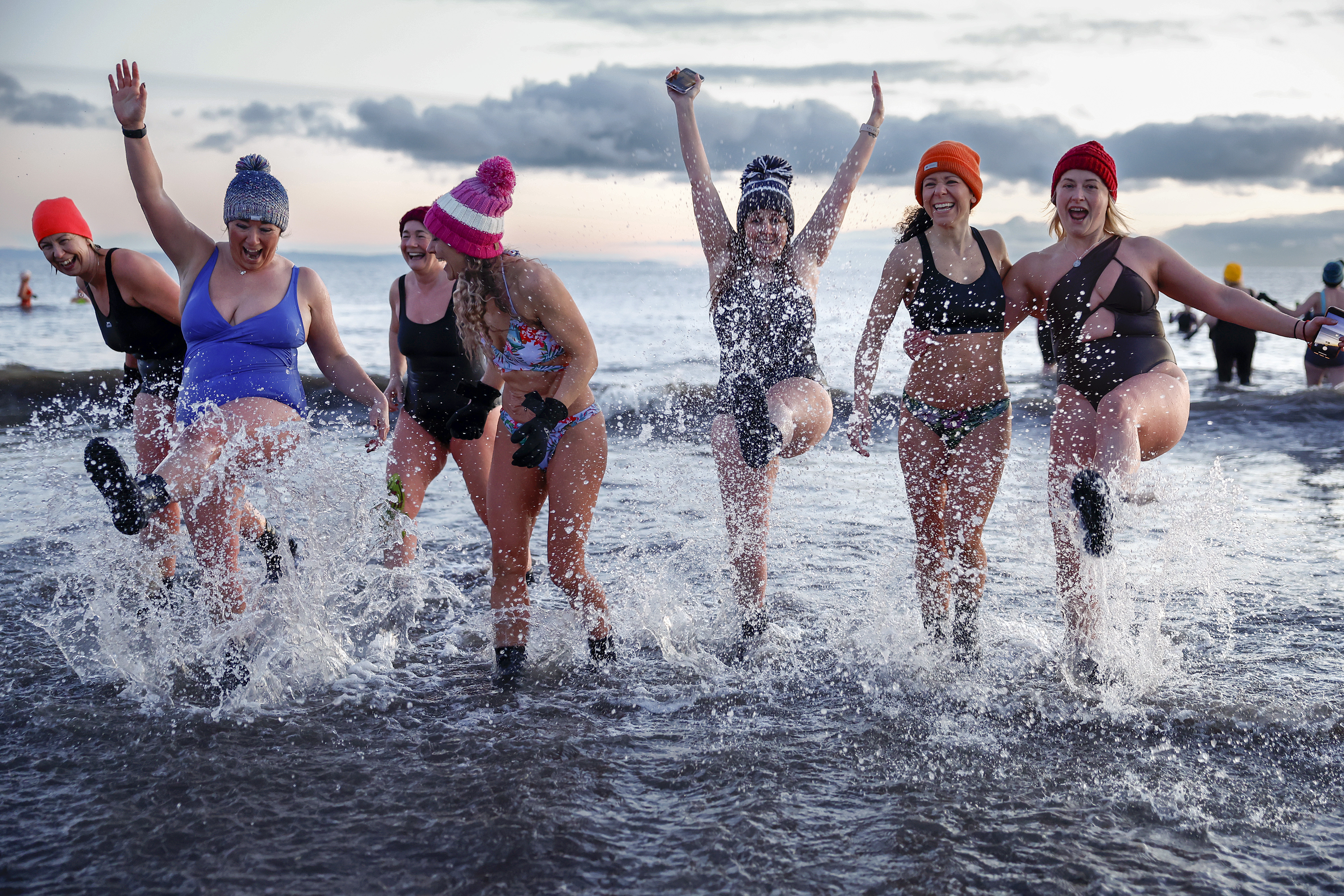 Edinburgh March 8: Hundreds of swimmers took a sunrise dip in the North Sea at Portobello Beach, for the International Women’s Day on March 8, 2023 in Edinburgh. The event was organised as a fundraiser for Women's Aid, which aims to end domestic violence against women and children. (Photo by Jeff J Mitchell/Getty Images)