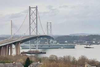 Royal Navy’s largest and most powerful warship sails under Forth Bridges
