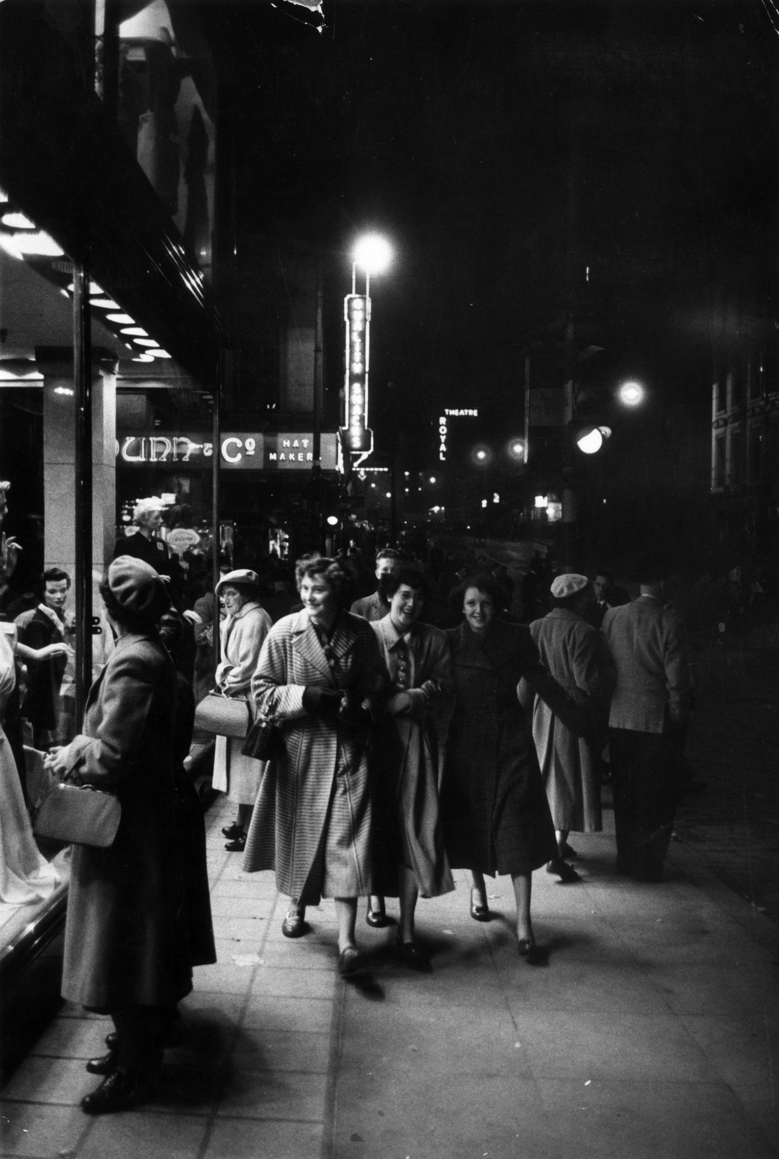 October 17 1953:  Three women enjoy window shopping among the Saturday night crowds on Sauchiehall street, Glasgow. Original Publication: Picture Post - 6754 - Glasgow: How A City Is Run - pub. 1953  (Photo by Haywood Magee/Picture Post/Hulton Archive/Getty Images)