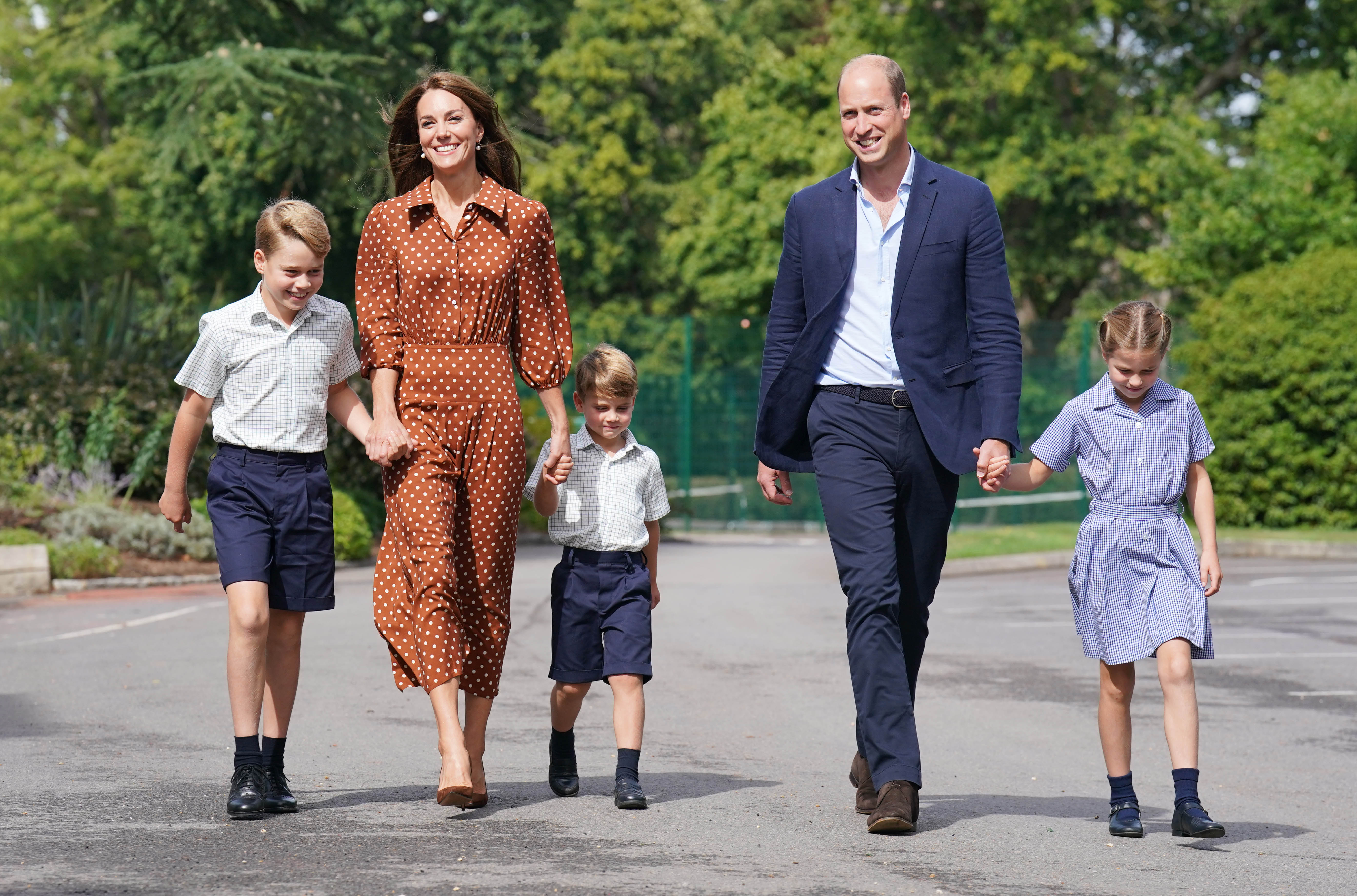 Prince George, Princess Charlotte and Prince Louis (C), accompanied by their parents the Prince William and Princess Catherine.