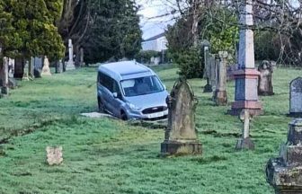 Van pictured stuck on top of graves at cemetery in Dunfermline