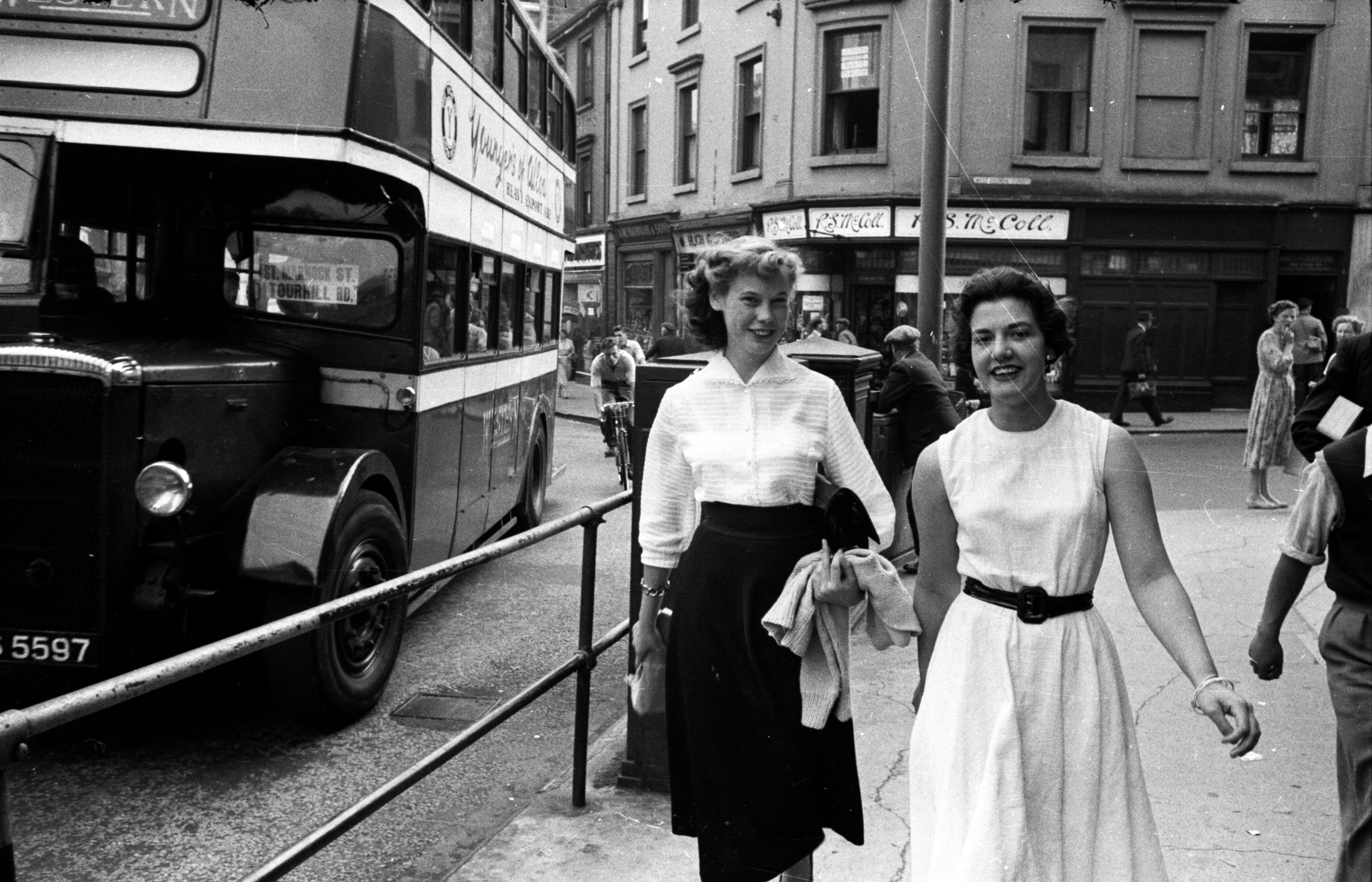 October 1 1955:  Two young women strolling down a busy street in the Scottish industrial town of Kilmarnock. Original Publication: Picture Post - 8024 - Is Auld Killie Slump-Proof? - pub. 1955  (Photo by Malcolm Dunbar/Picture Post/Hulton Archive/Getty Images)