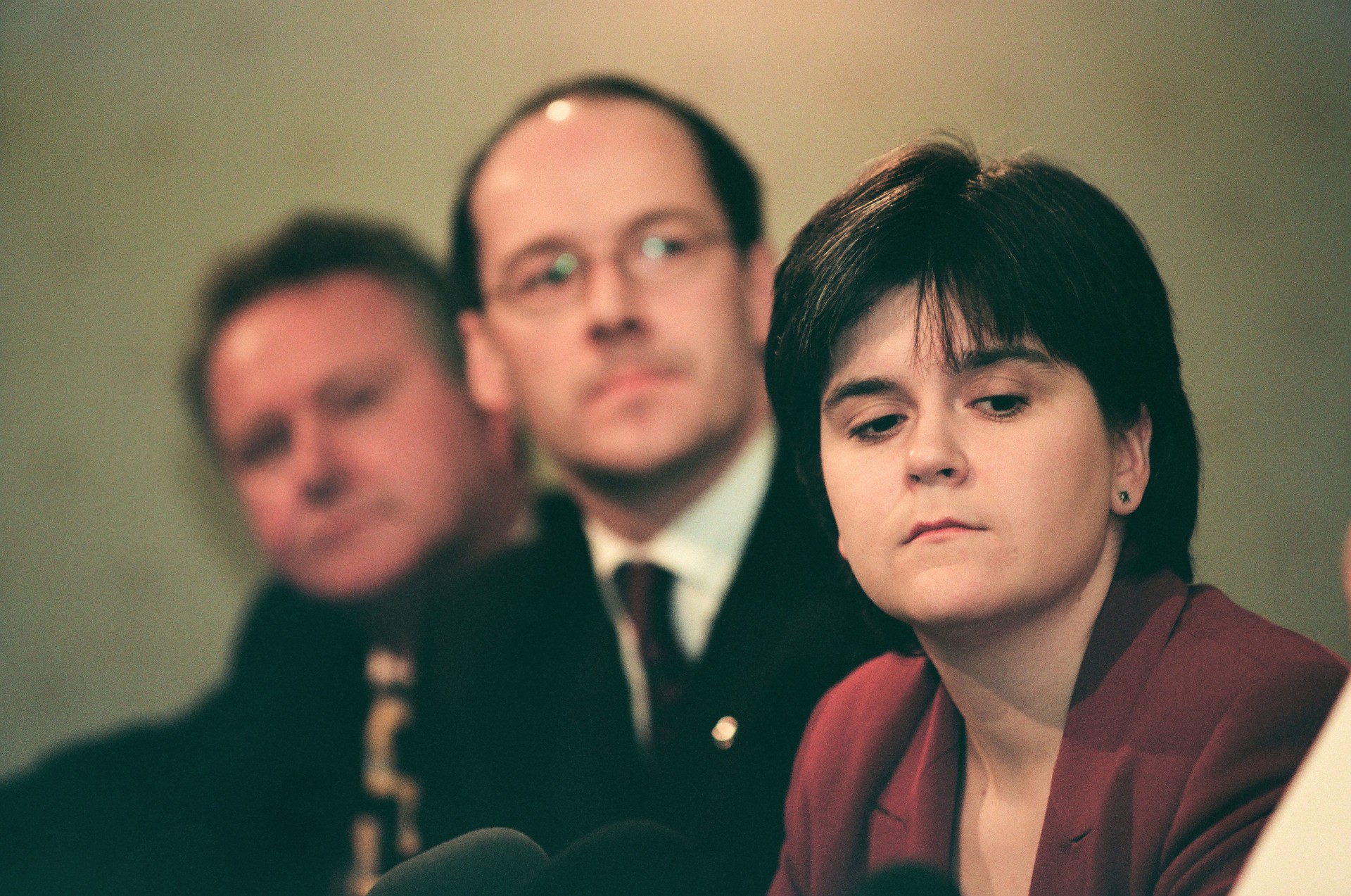 The Scottish National Party's Nicola Sturgeon (right) with John Swinney behind her listening to party leader Alex Salmond addressing the media at the launch of the SNP's 1999 manifesto for the Holyrood election campaign.