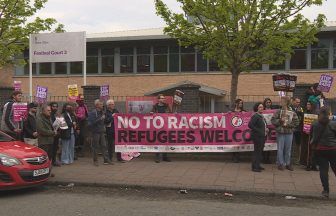 Activists protest deportation of refugees outside of Home Office in Glasgow amid Rwanda policy