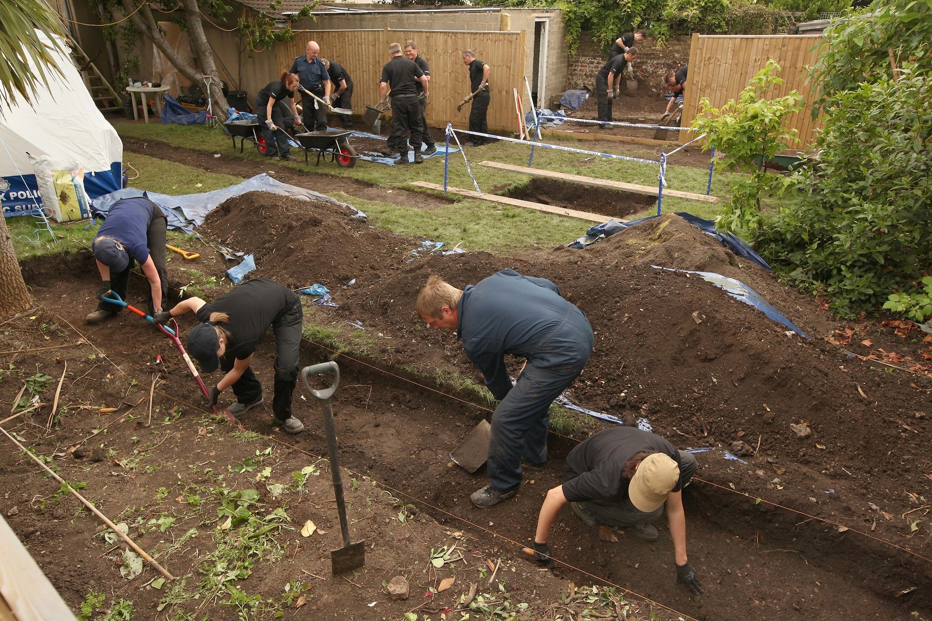 Police search the garden of a property where Peter Tobin lived in Portslade on July 14, 2010 near Brighton.